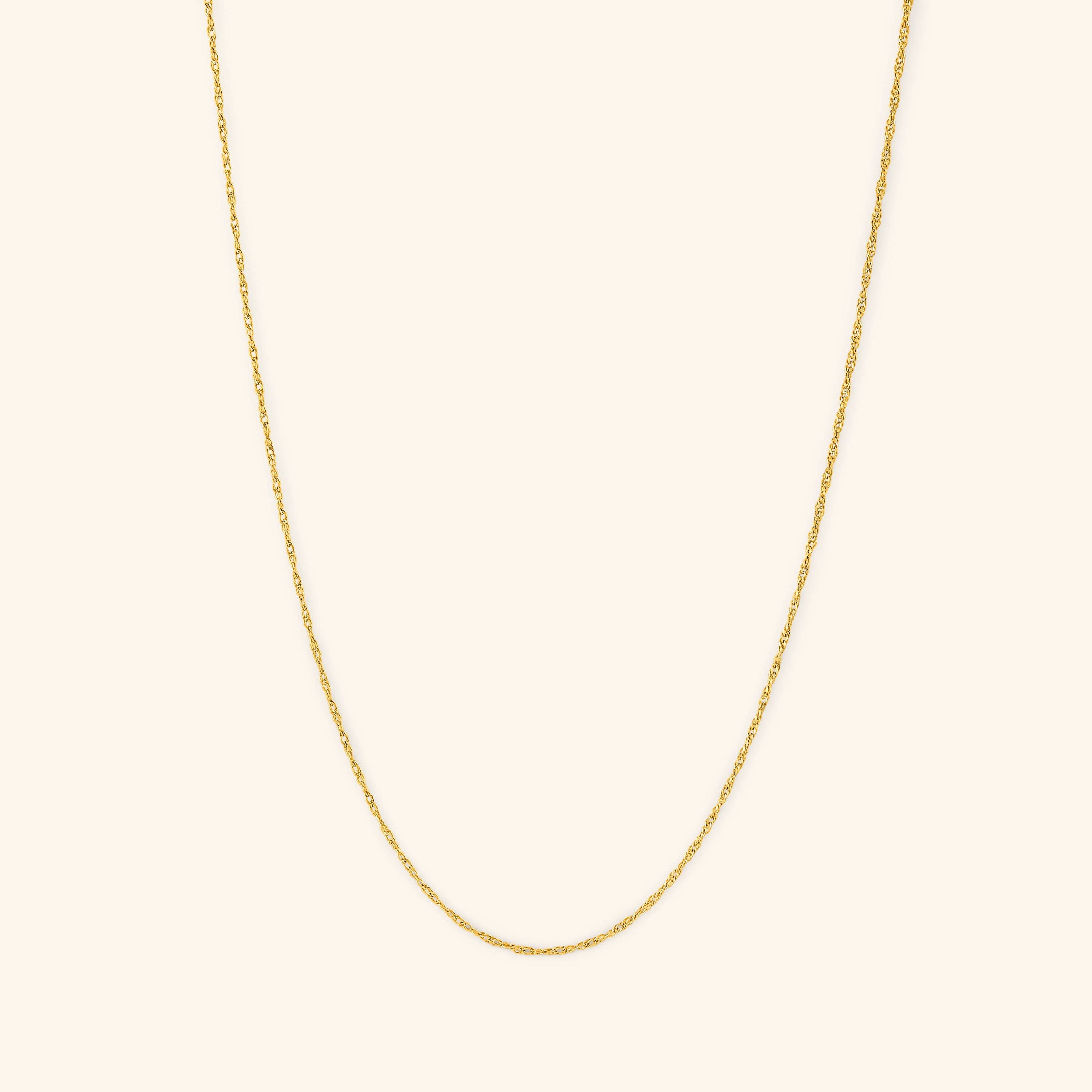 Elegant twisted gold chain necklace displayed on a model, showcasing its delicate design.