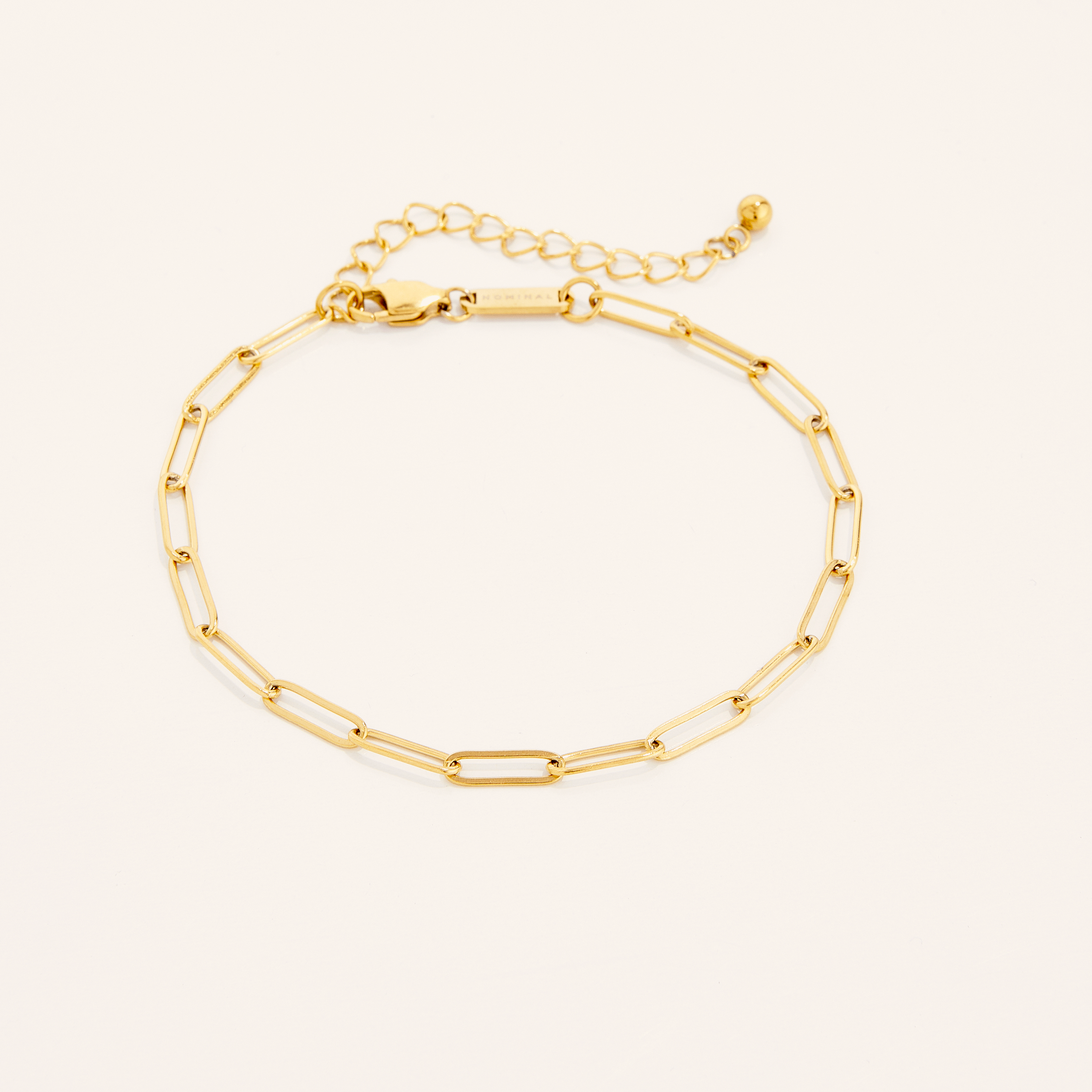 Elegant gold chain anklet displayed on a model's ankle, highlighting its delicate design and fit.