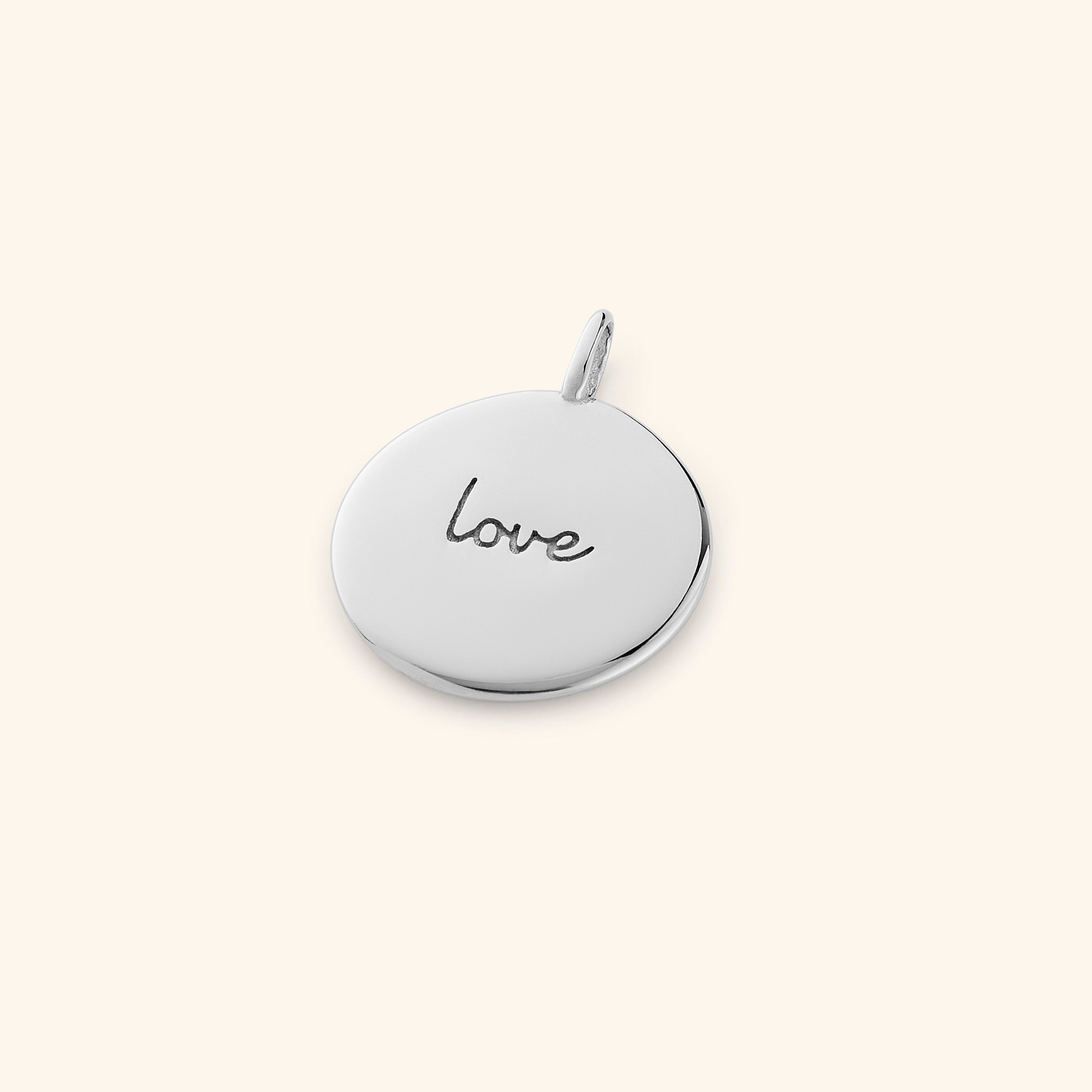 Eternal Love Charm showcasing intricate engraving in Arabic and English.