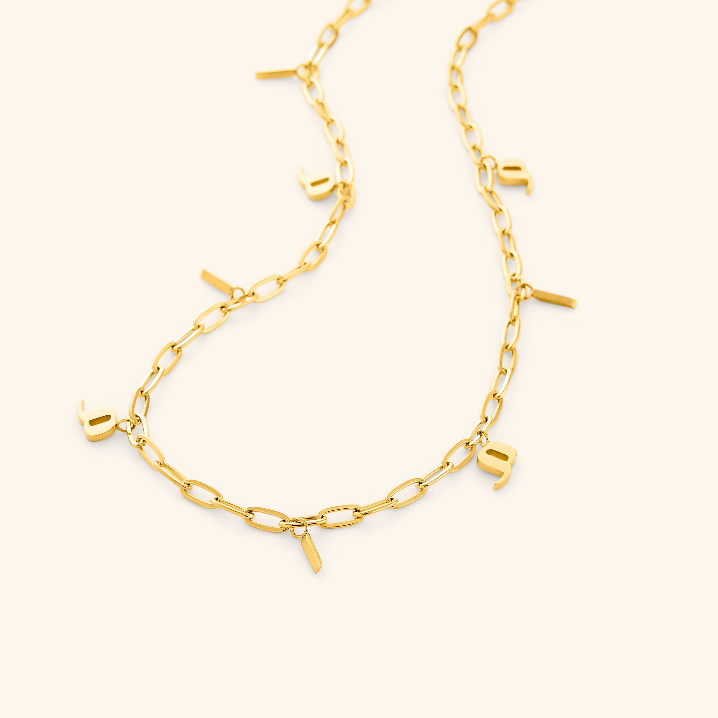 Close-up of the personalized mama charm necklace showcasing its elegant gold finish and Arabic letters.