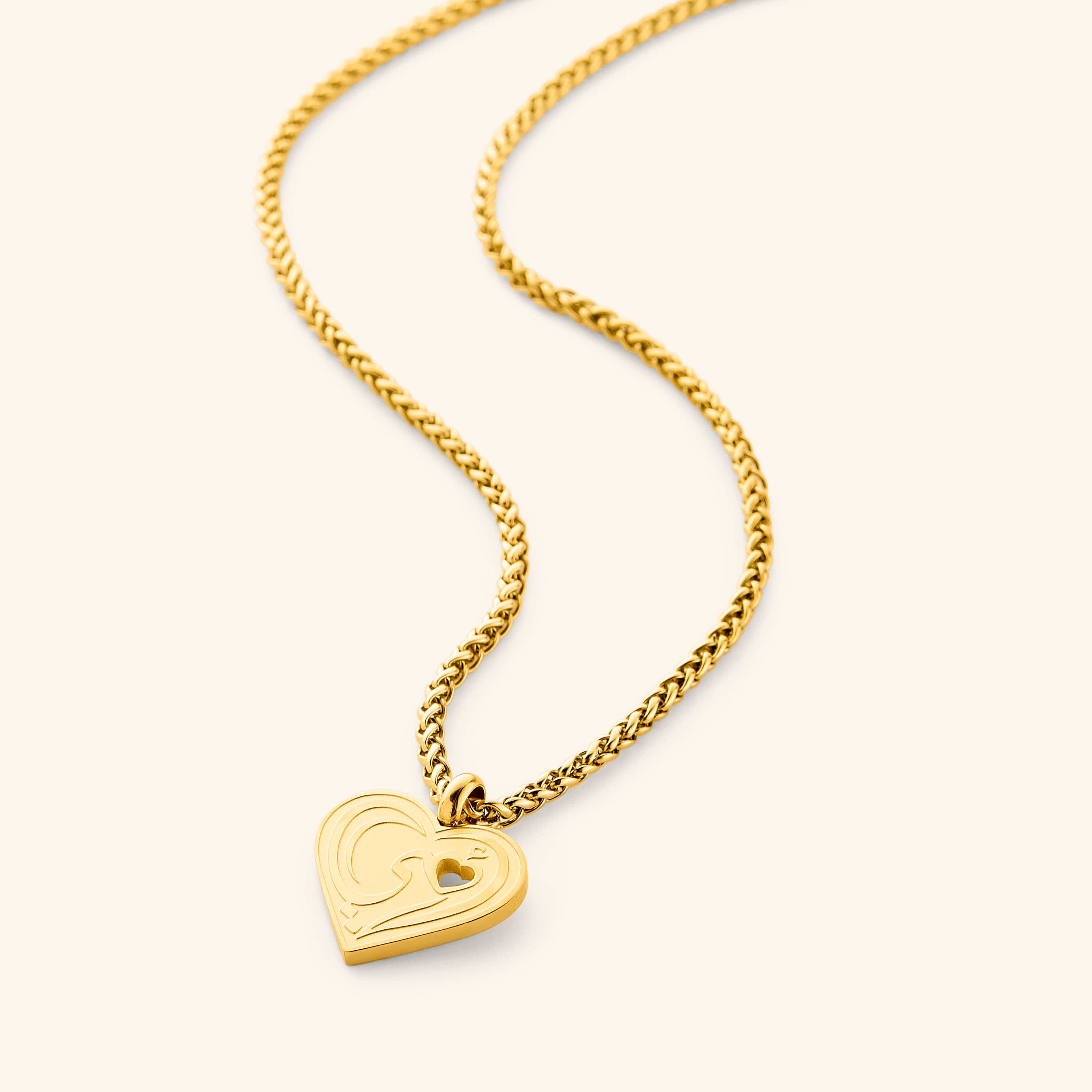 Heartfelt Mama Necklace displayed elegantly on a velvet pouch, showcasing its Arabic calligraphy.