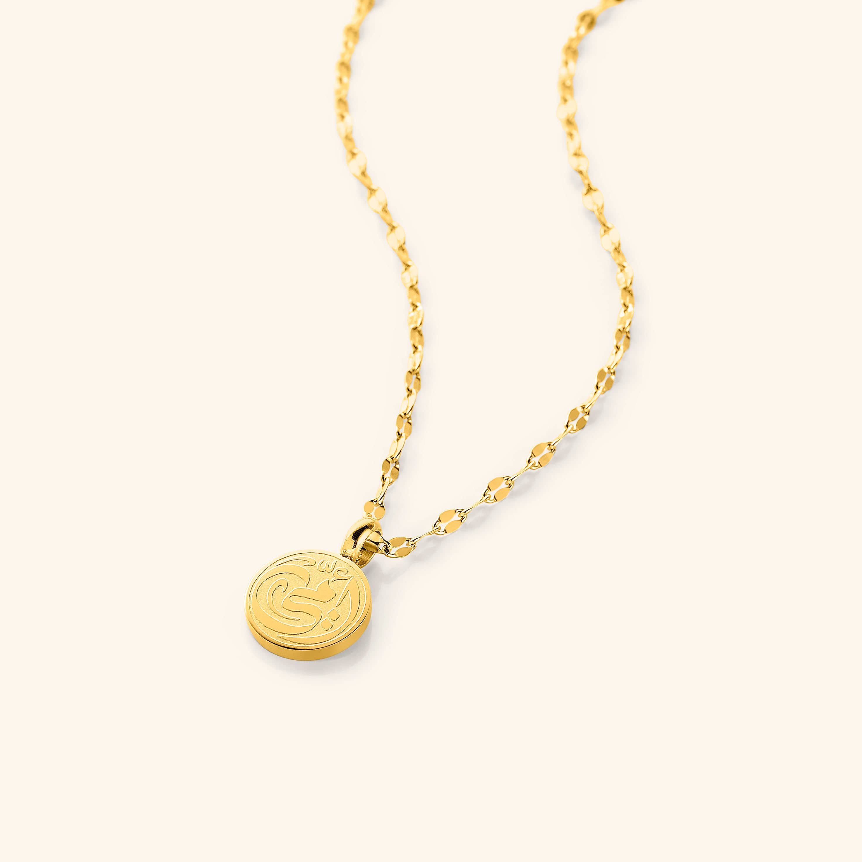 Elegant Arabic calligraphy mother necklace on display, showcasing its intricate design and gold finish.