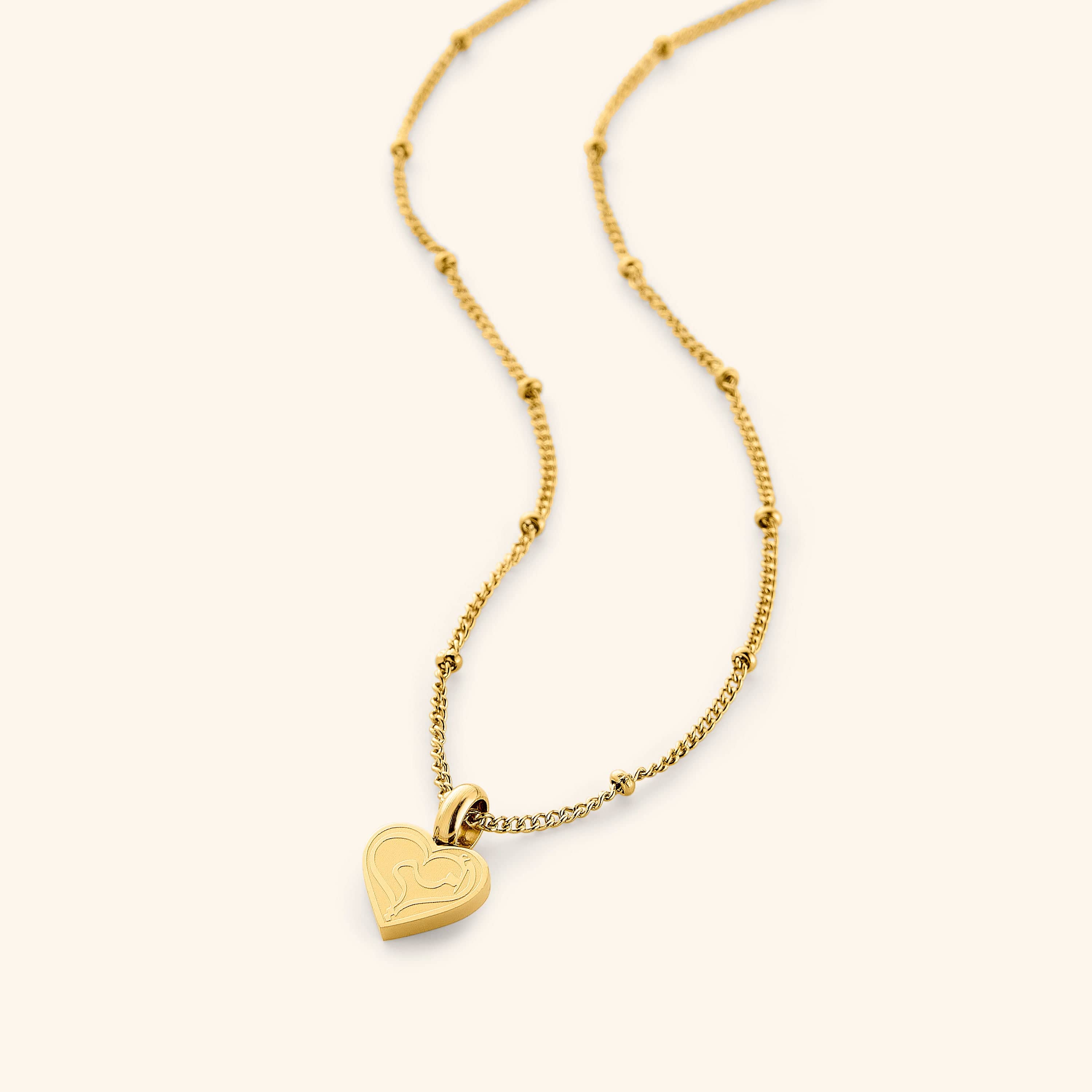 Heart charm necklace for mom featuring 'ummi' engraved on 18K gold-plated stainless steel, designed with a dotted chain.