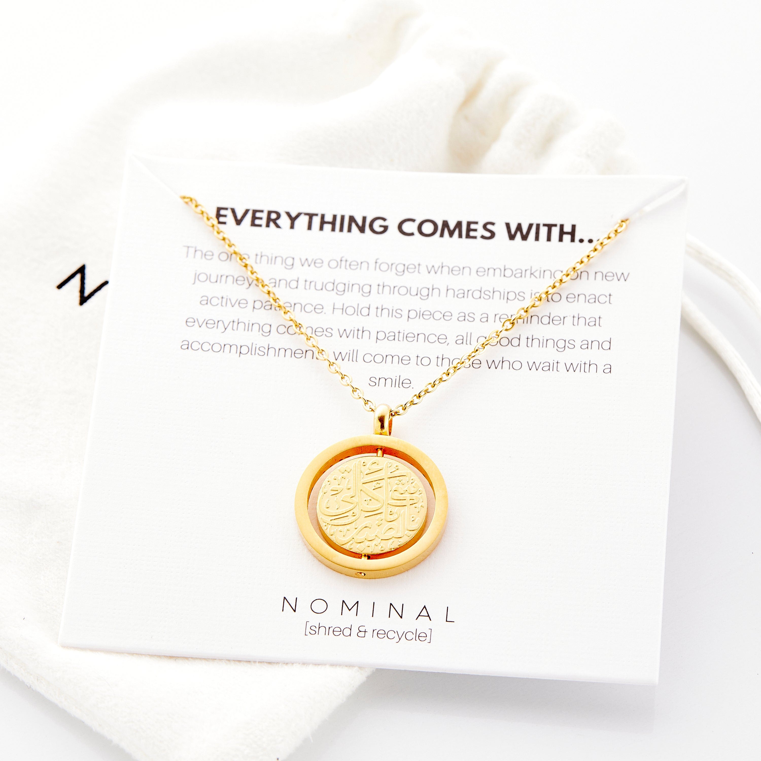 The Patience is Key necklace displayed in a velvet drawstring pouch, perfect for gifting.