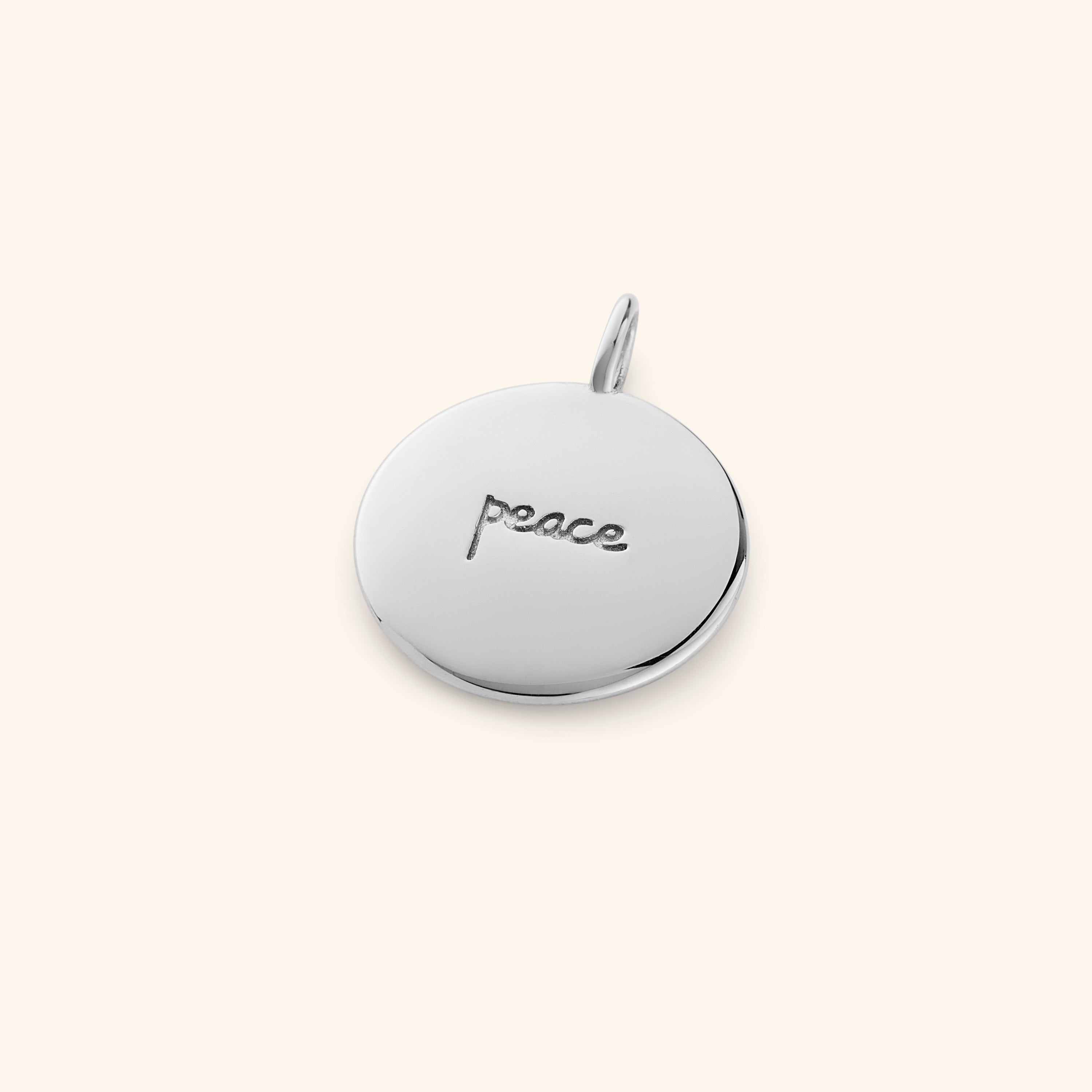 Serenity Gold Charm with Arabic engraving showing peace.