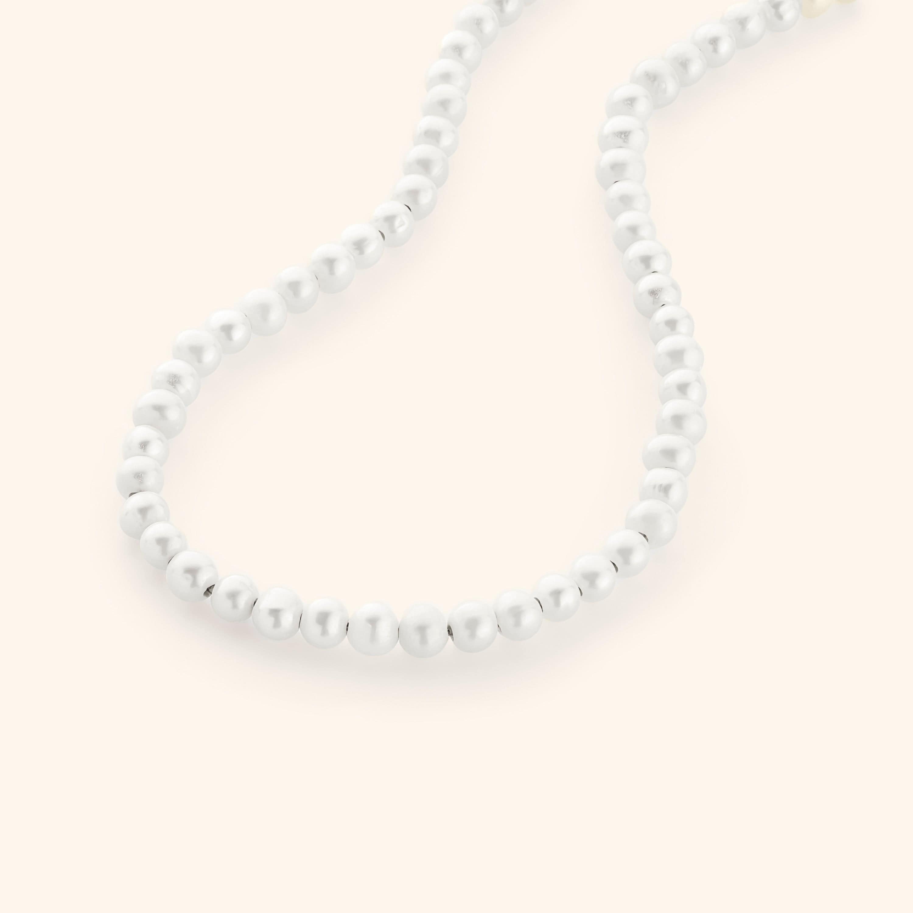 Close-up of freshwater pearls layered along 18k gold chain, ideal as affordable pearl necklace gift for her