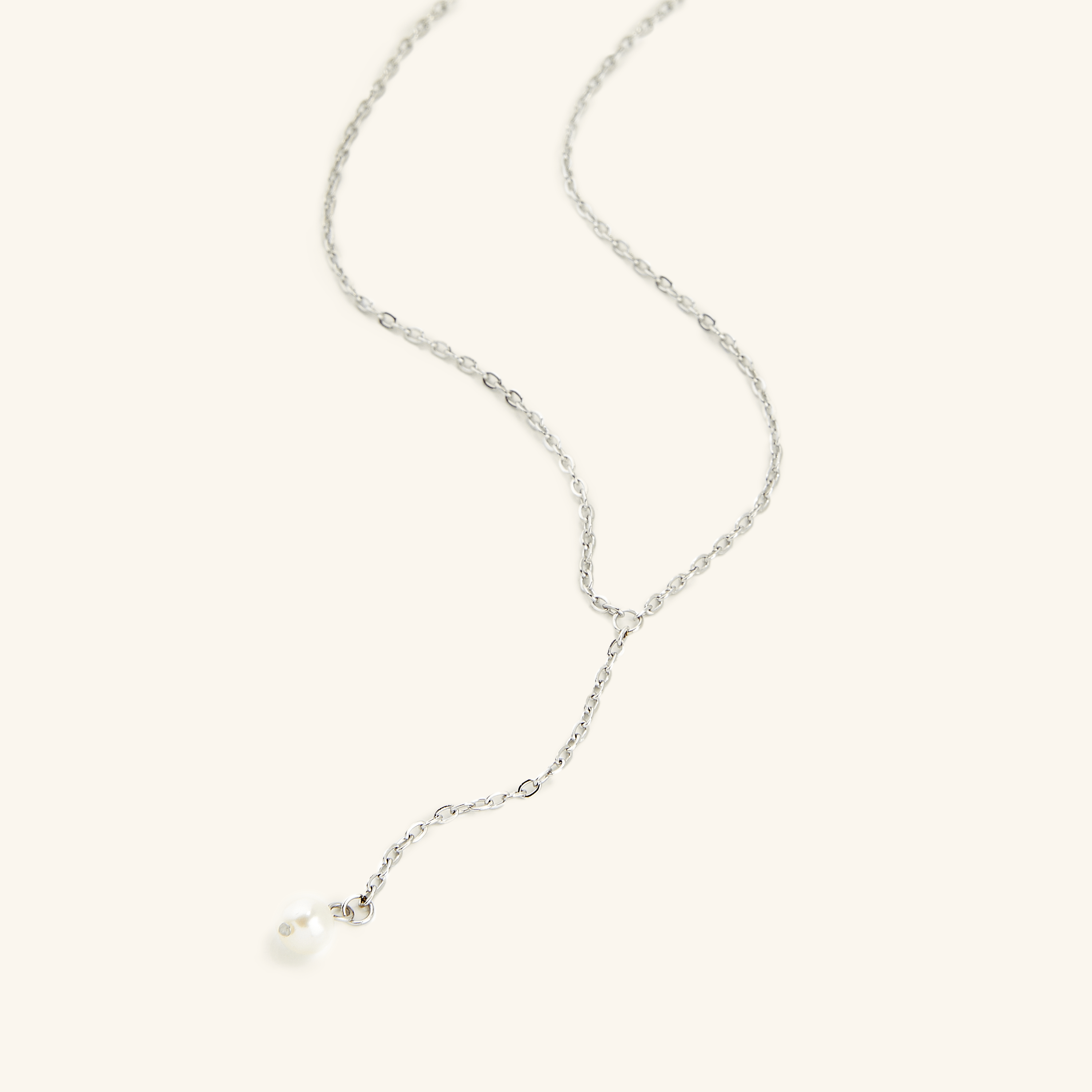 Luxury gold pearl necklace with lariat design, highlighting the stunning freshwater pearl