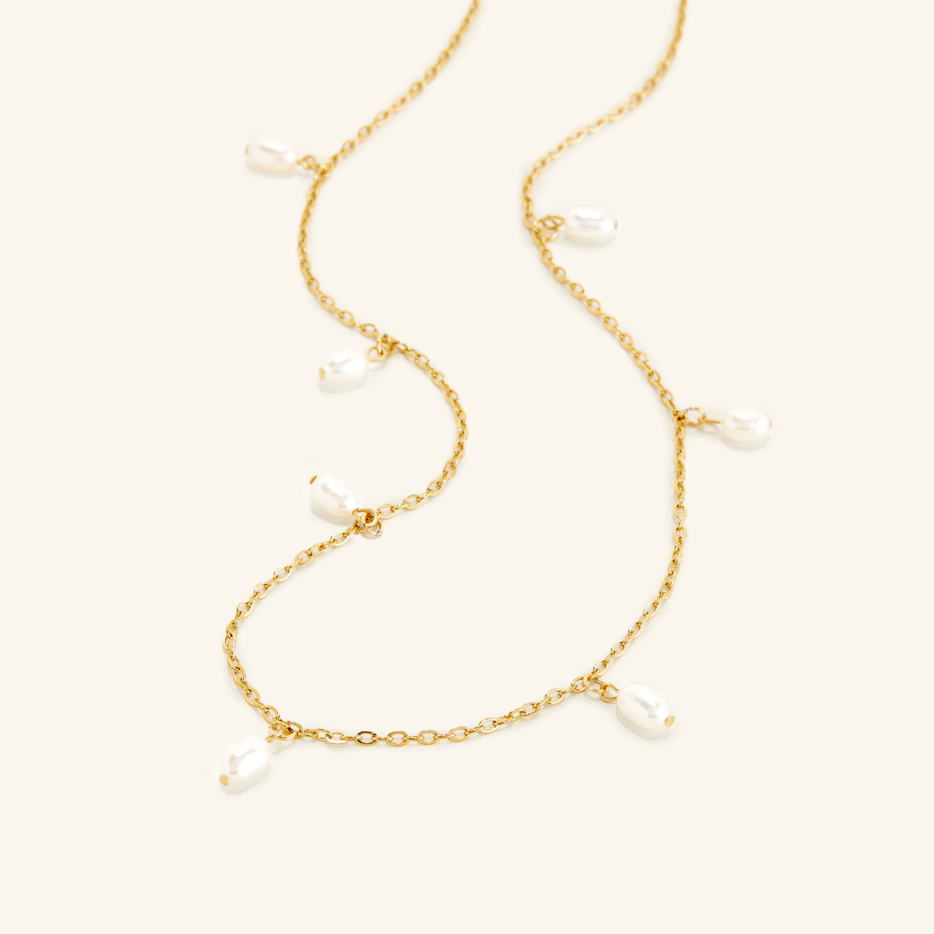Luminous Raining Pearls Necklace displayed on a white background, showcasing the elegant pearl droplets.