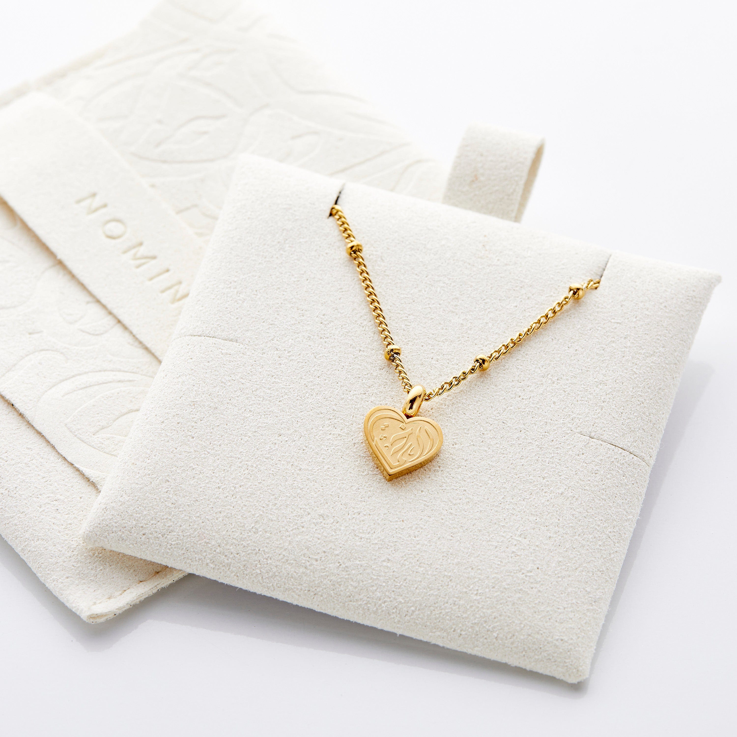 Packaging of cheap gold sister jewelry in a velvet pouch, ready for gifting.