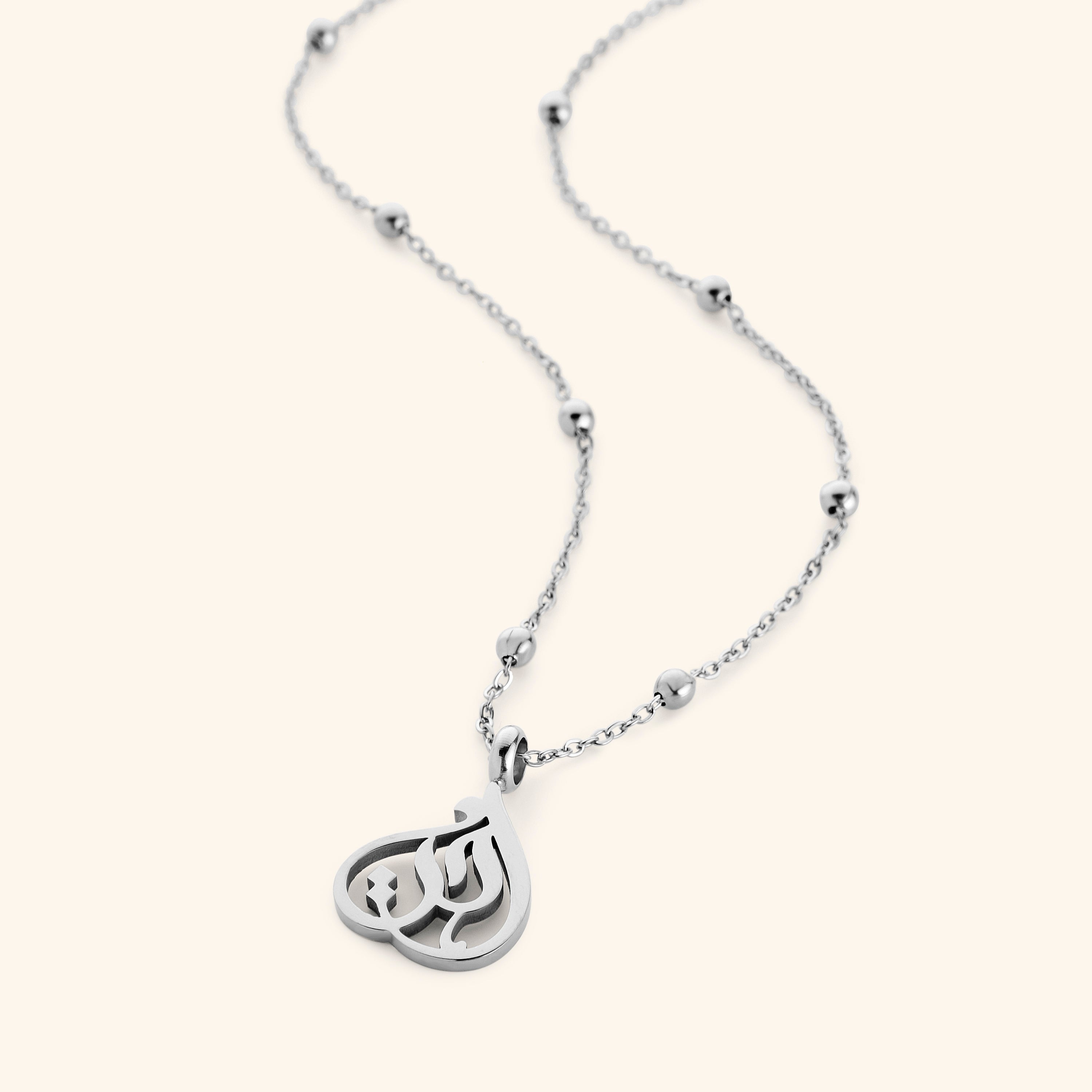 Model wearing the affordable sister necklace with calligraphy outdoors
