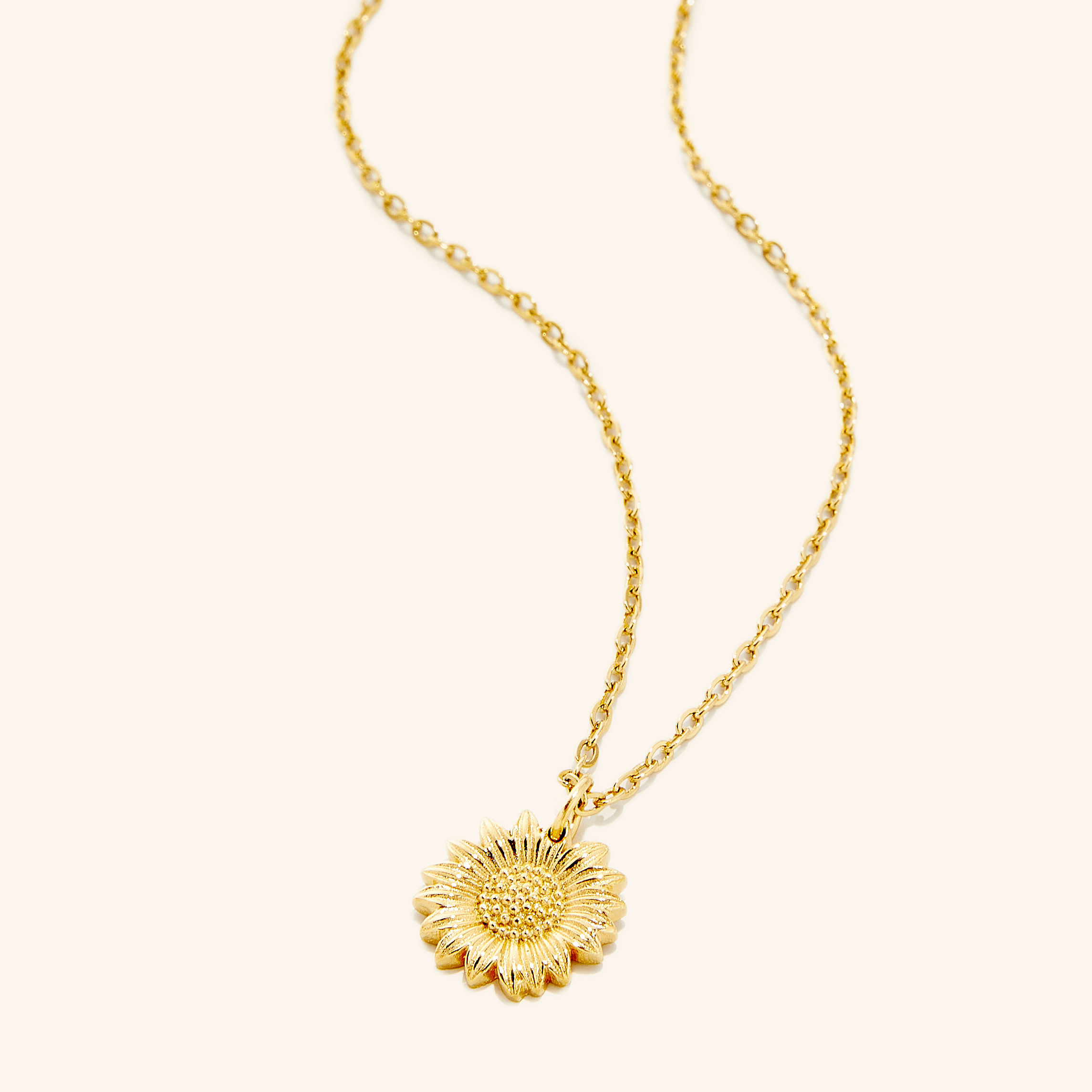 Close-up of the radiant sunflower necklace highlighting its delicate details.