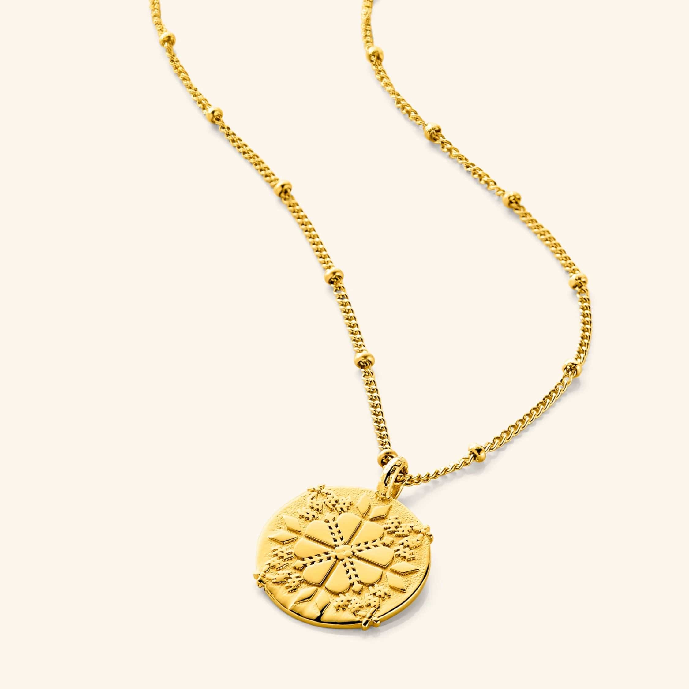 Tatreez necklace displayed elegantly on a velvet background, highlighting its intricate design.