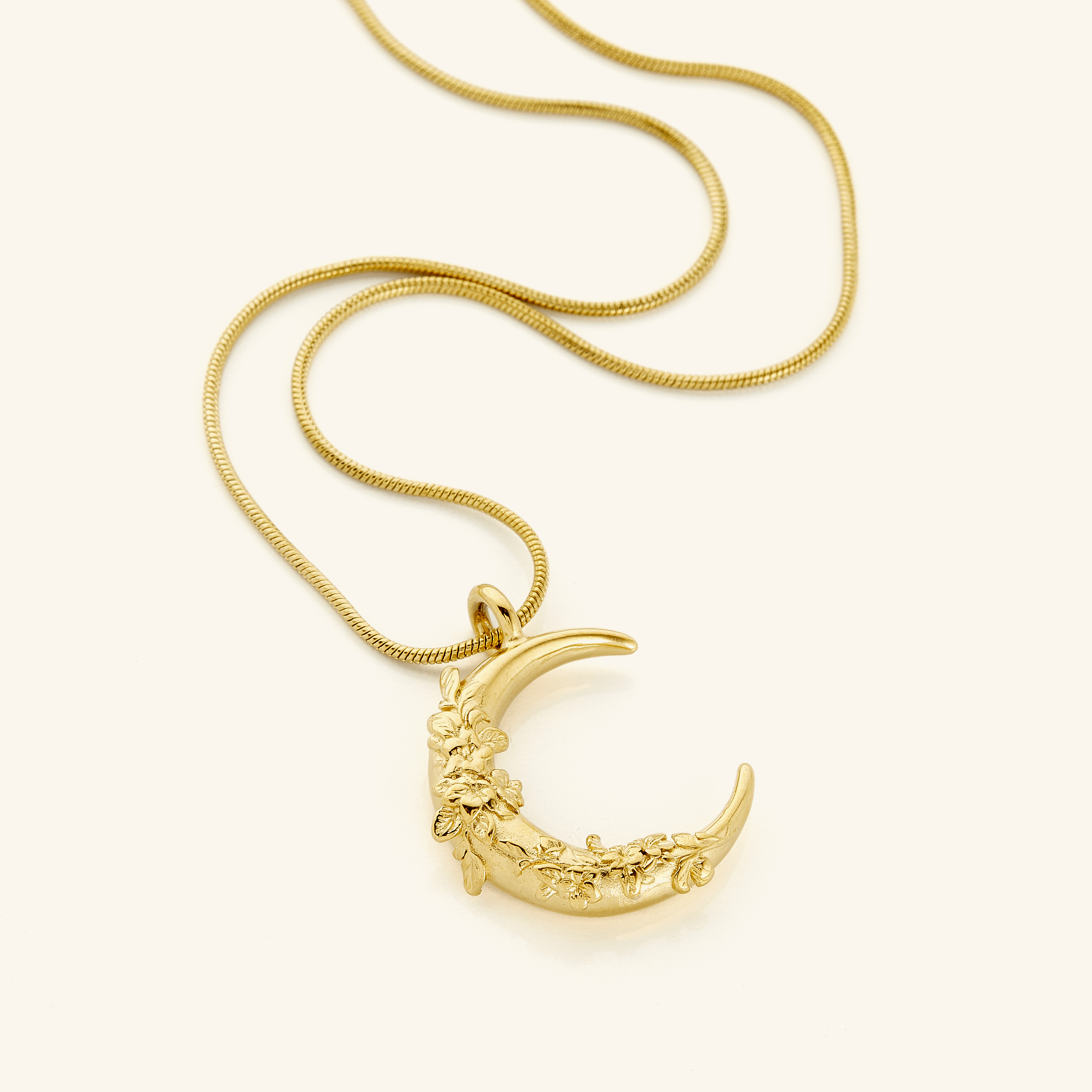 Close-up view of the celestial jasmine crescent pendant necklace highlighting intricate details.
