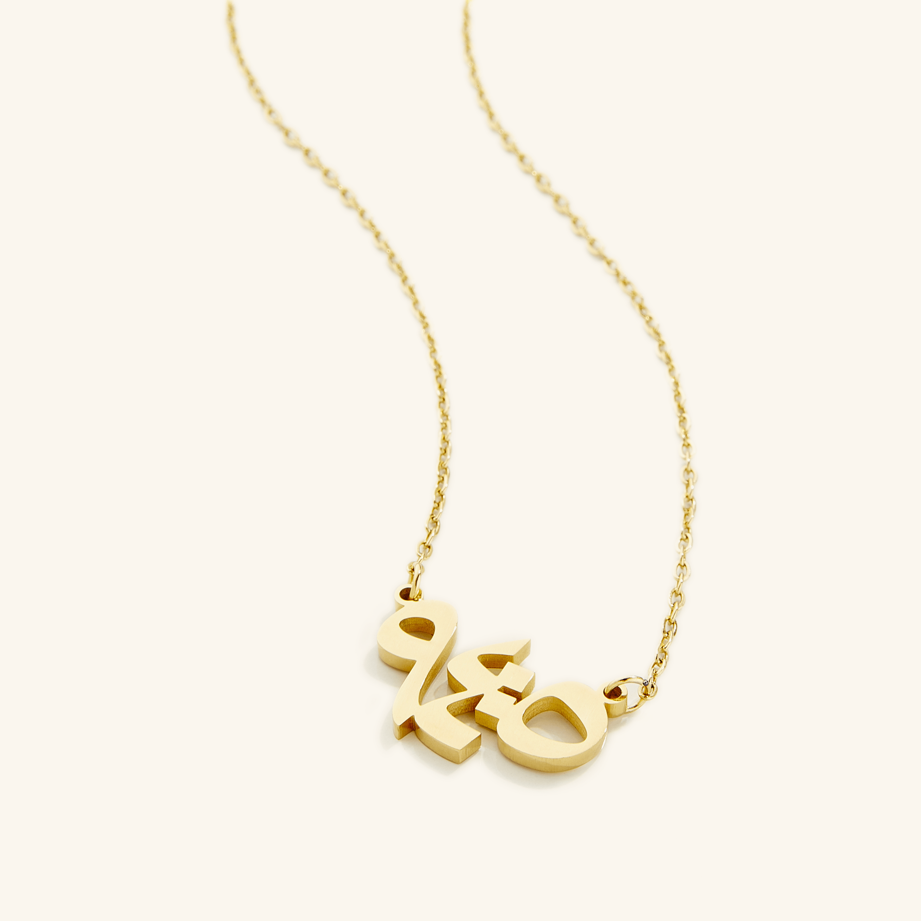 Close-up of the Embrace Serenity verse necklace showcasing intricate Arabic calligraphy