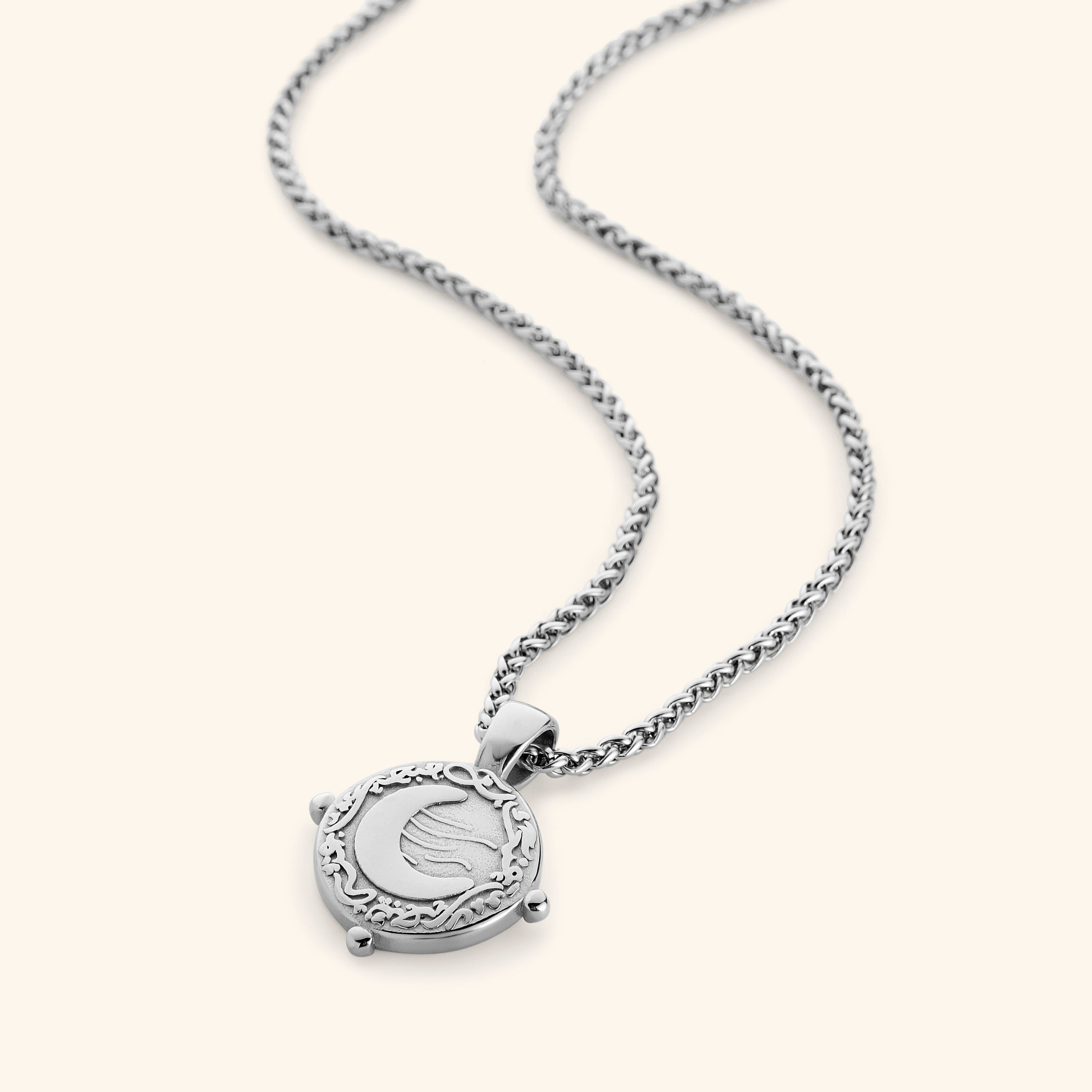 Detailed shot of the velvet pouch packaging for the crescent necklace.
