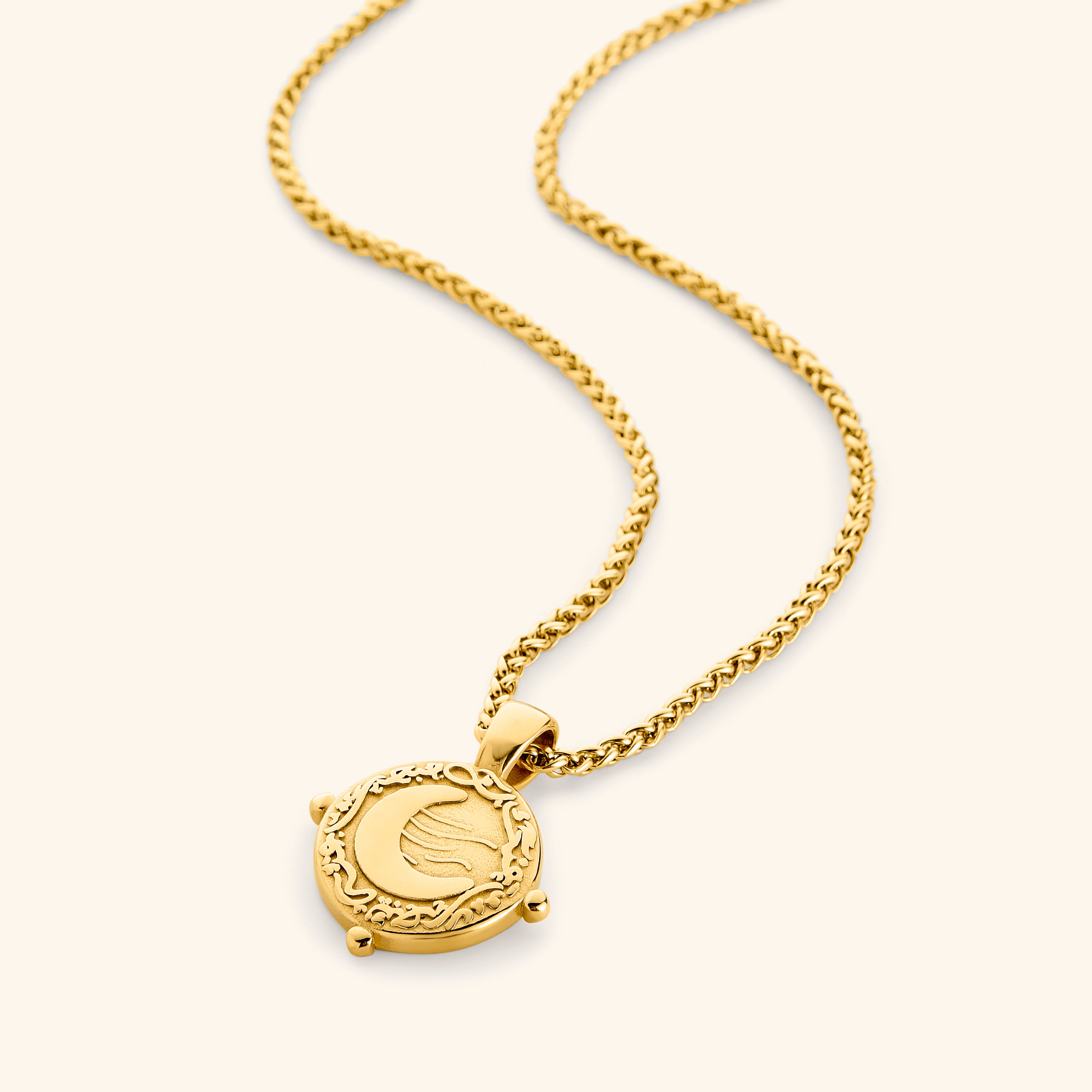 Close-up view of the vintage gold crescent necklace showcasing the Arabic pendant.