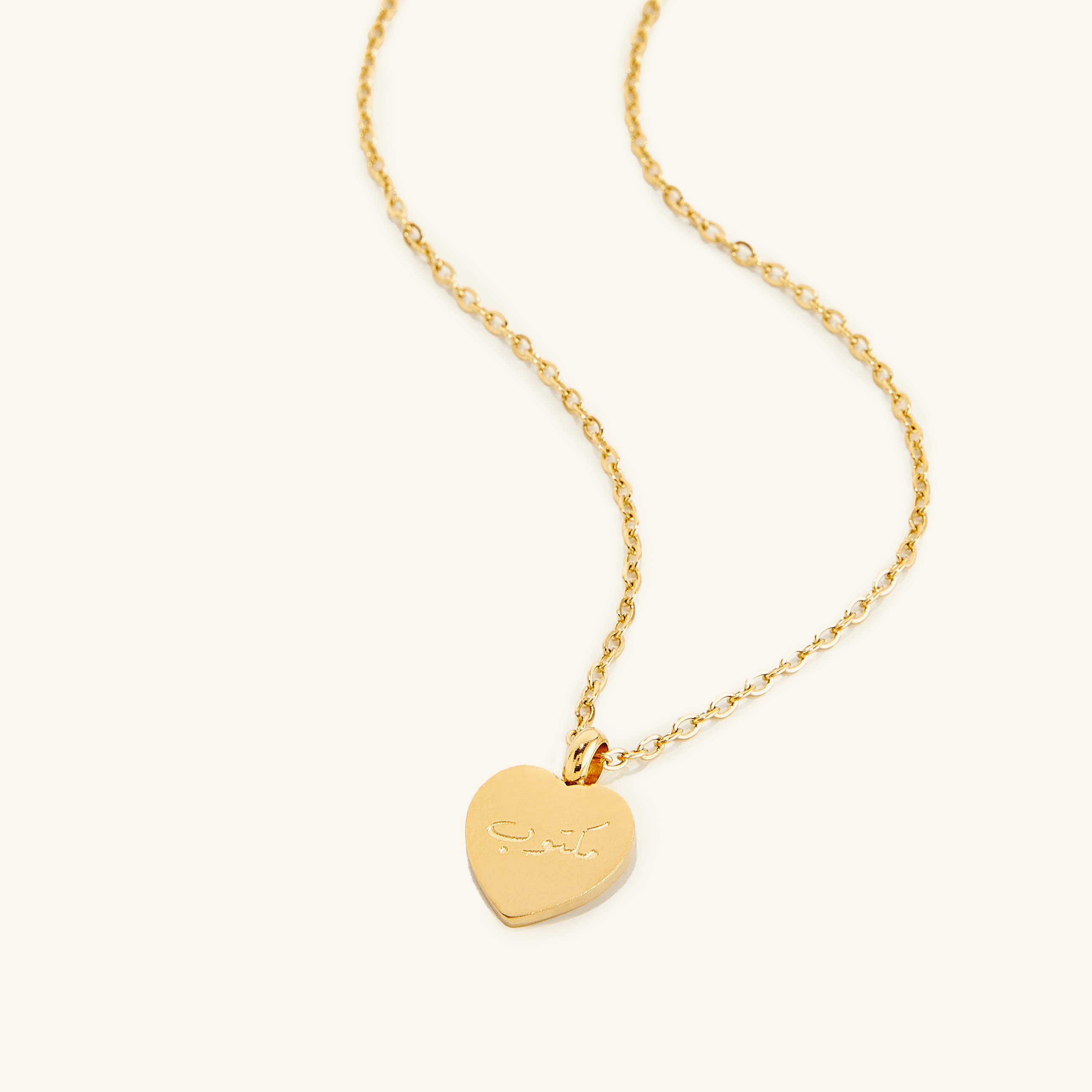 Gold charm necklace displayed on a soft velvet pouch, symbolizing personal journeys.
