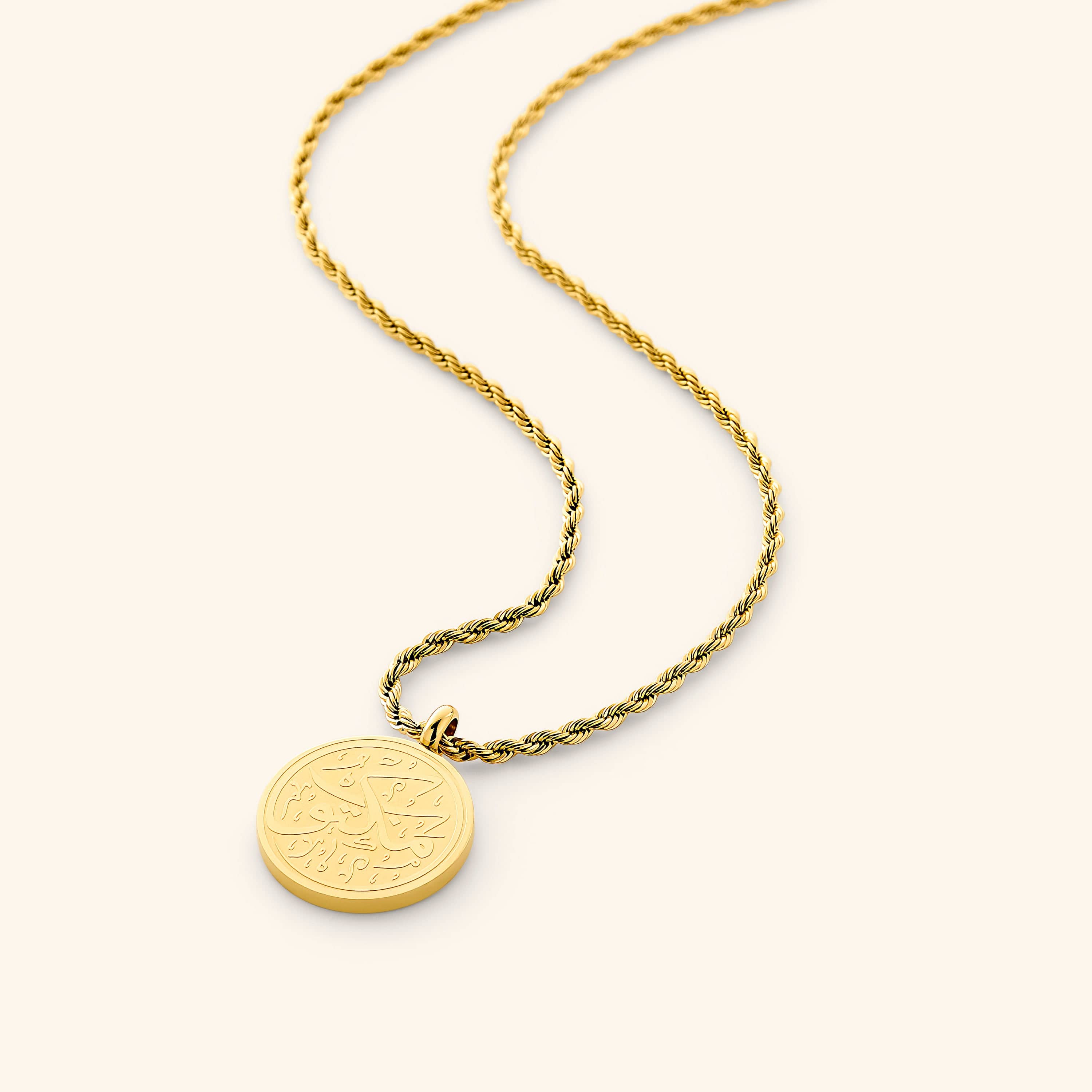 Close-up of the Maktub Arabic calligraphy token necklace showcasing the intricate design.