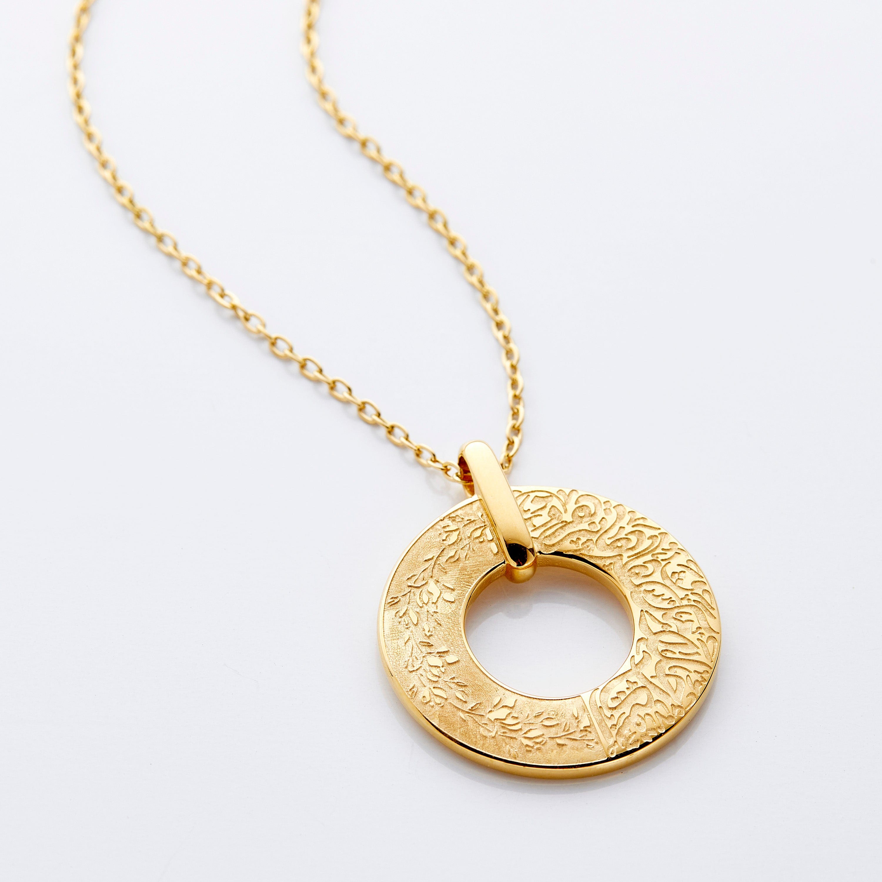 Dream Bloom Necklace showcasing the intricate olive leaves and Arabic engraving, perfect for women who love unique poetic jewelry.