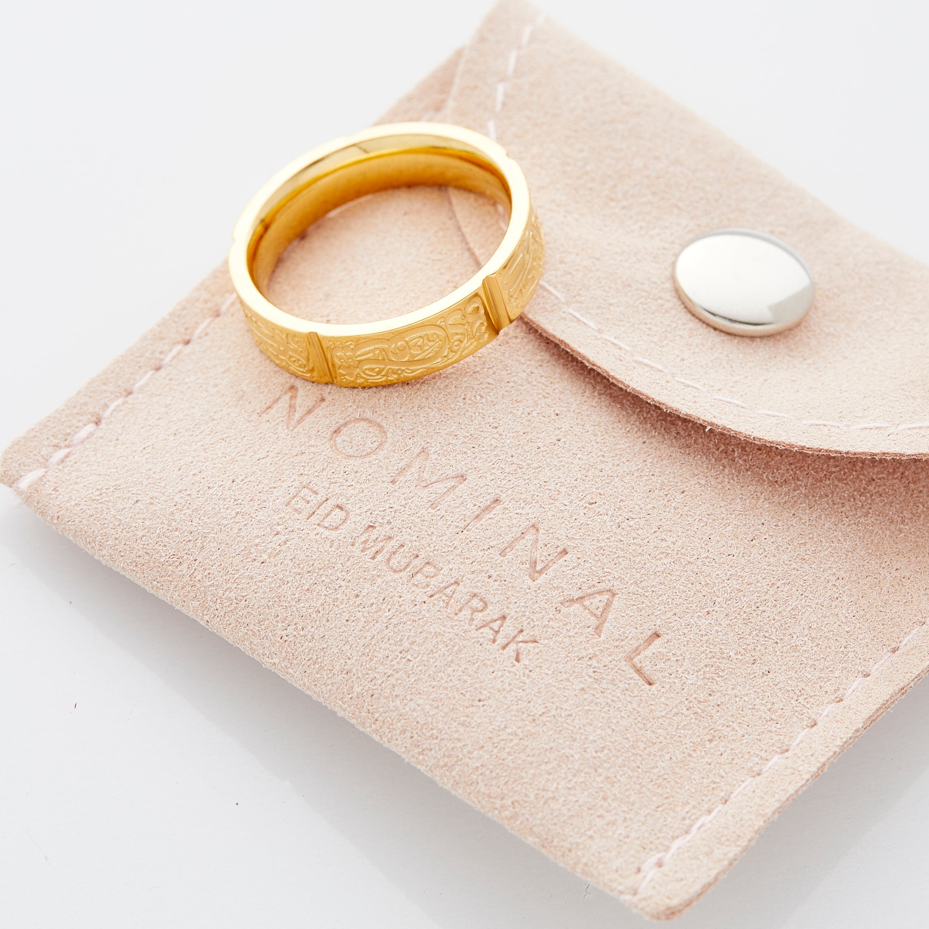 Elegant presentation of the Five Pillars Ring in its velvet Eid pouch.