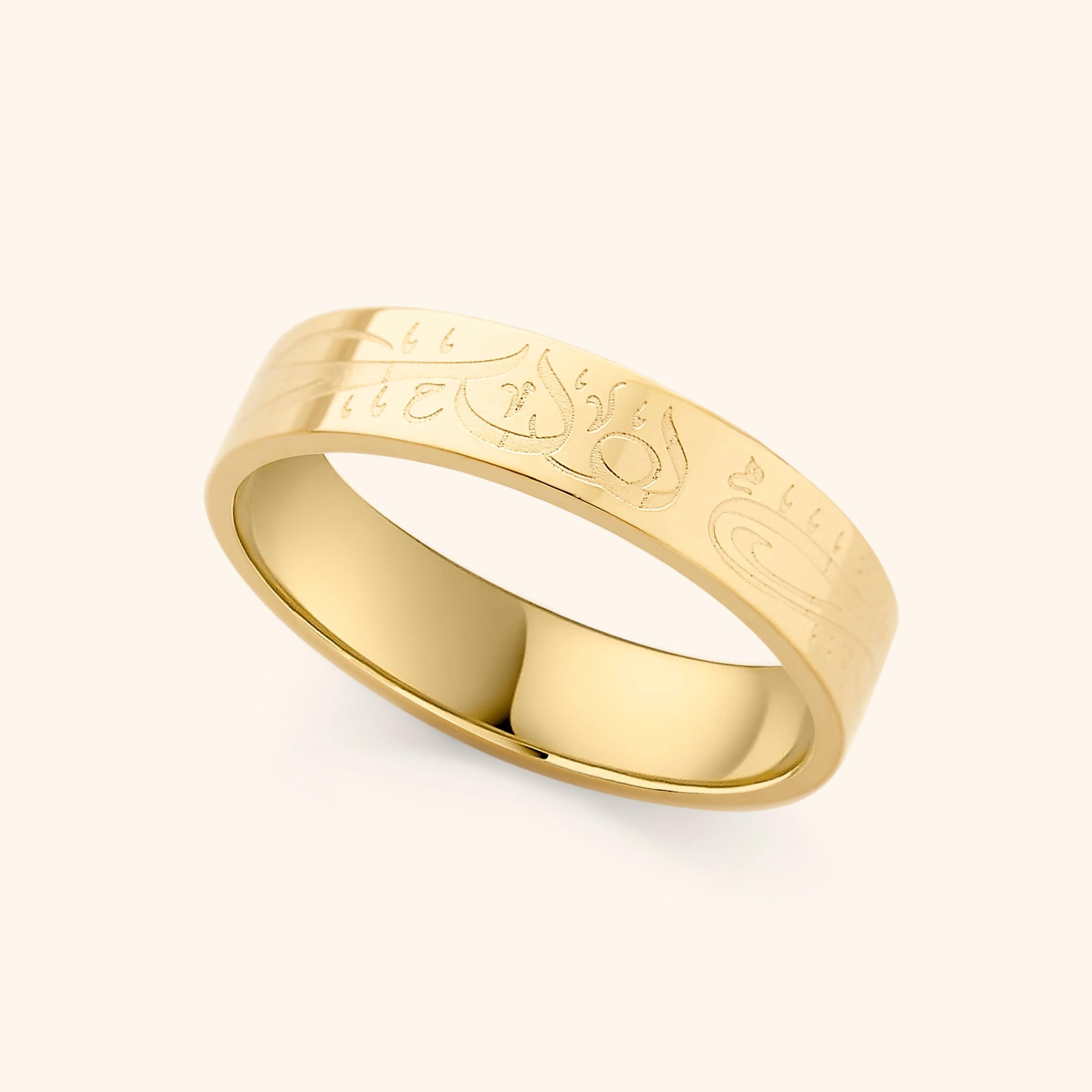 Close-up of the Alhamdulillah ring showing detailed Arabic engraving across stainless steel band