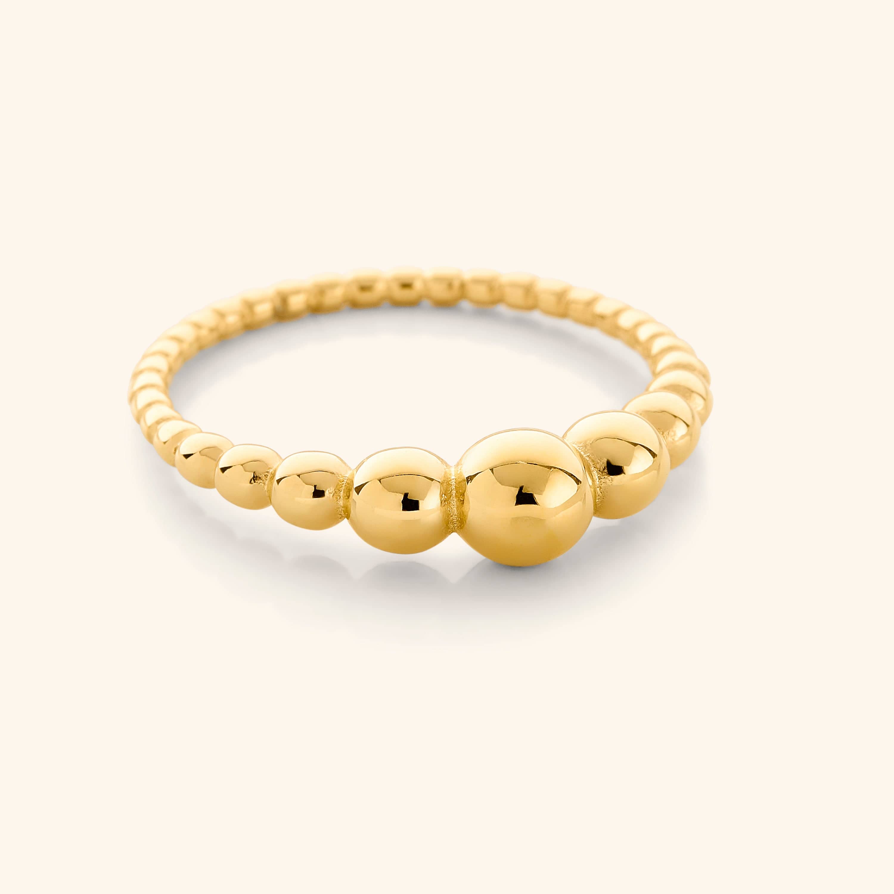 Chic Bubble Ring displayed in velvet pouch, highlighting its dainty design and 18K gold plating.