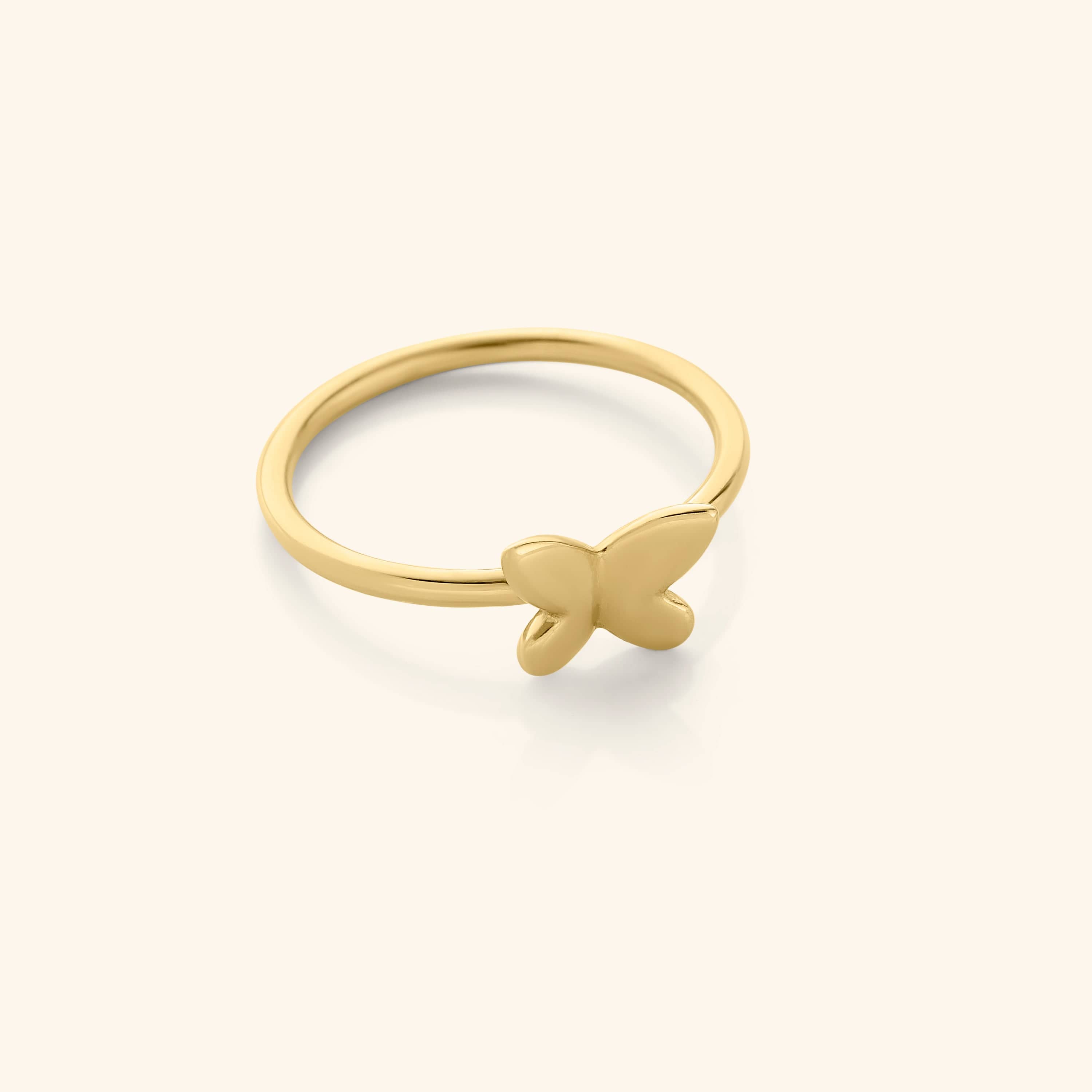 Close-up of the LunaFlair gold butterfly ring resting on a silk fabric, showcasing its delicate shape