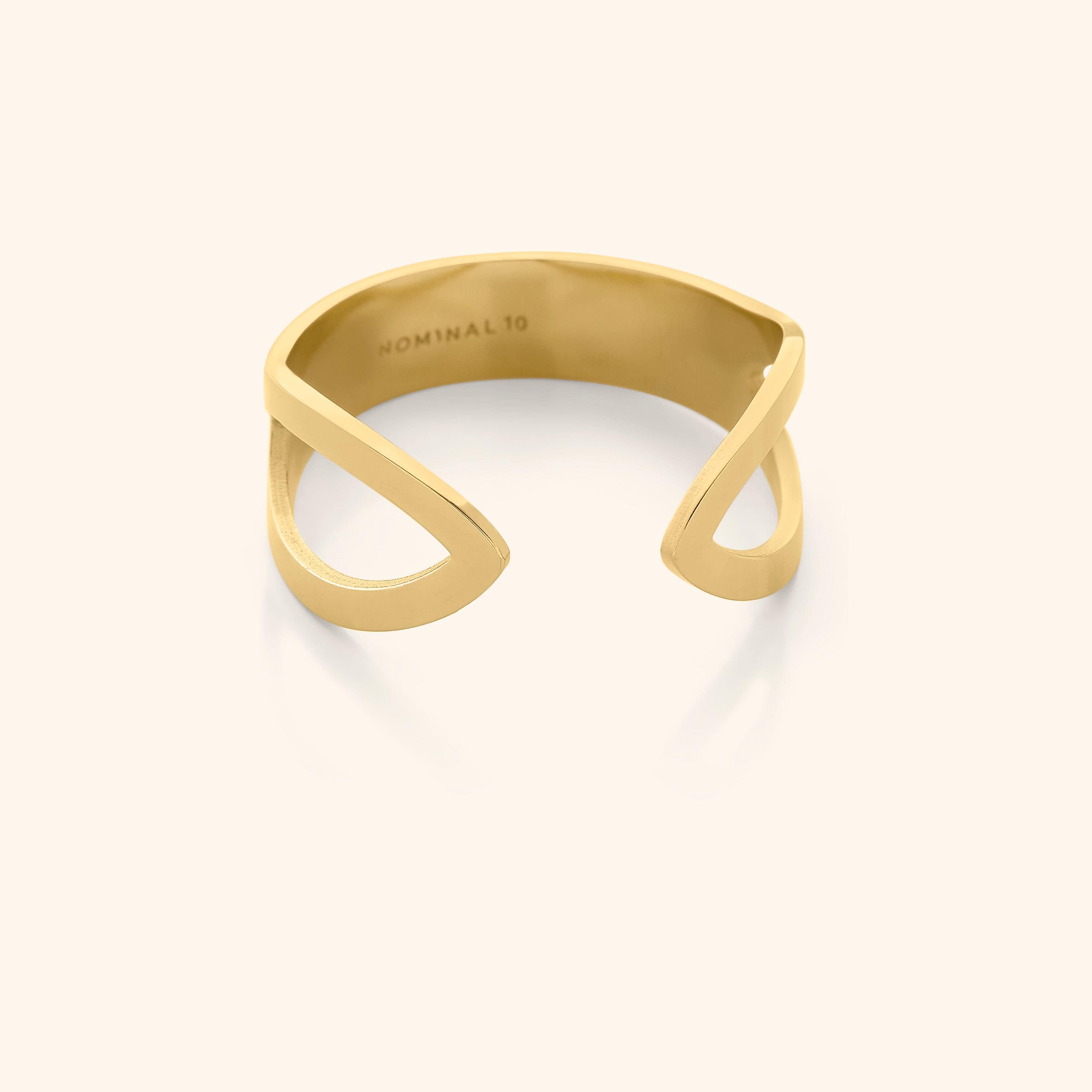 Close-up of Corridor Elegance Ring showcasing its tapered wing-like design and gold plating.