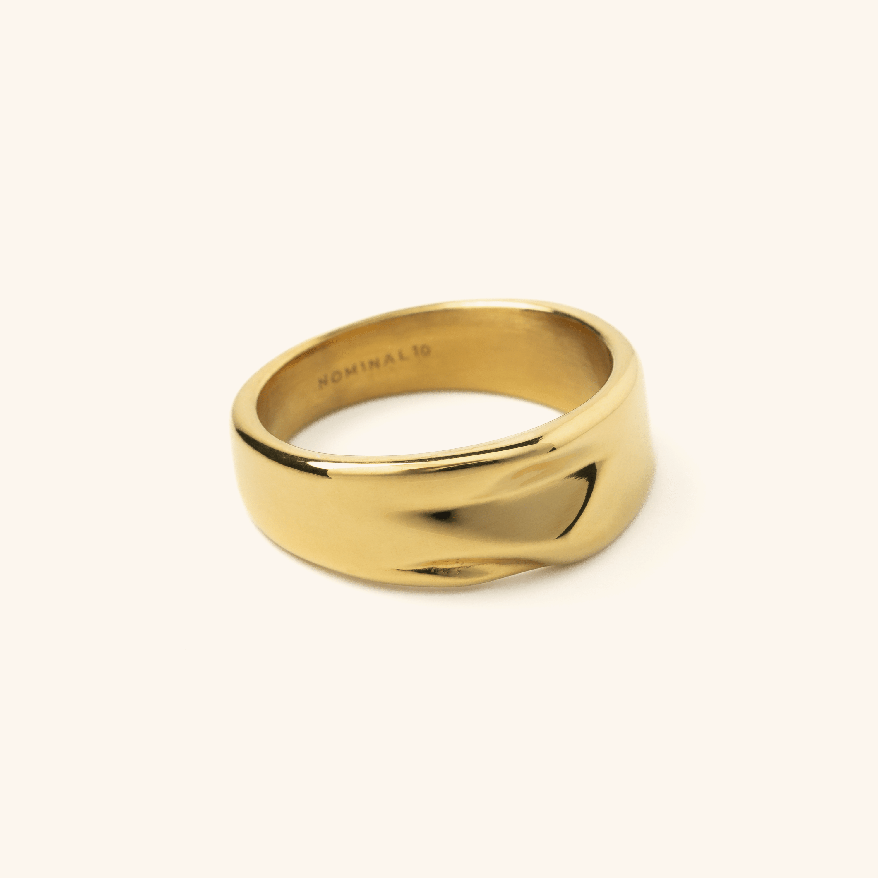 Close-up of the Elegance Droop Ring showcasing its unique drooping design and gold finish.