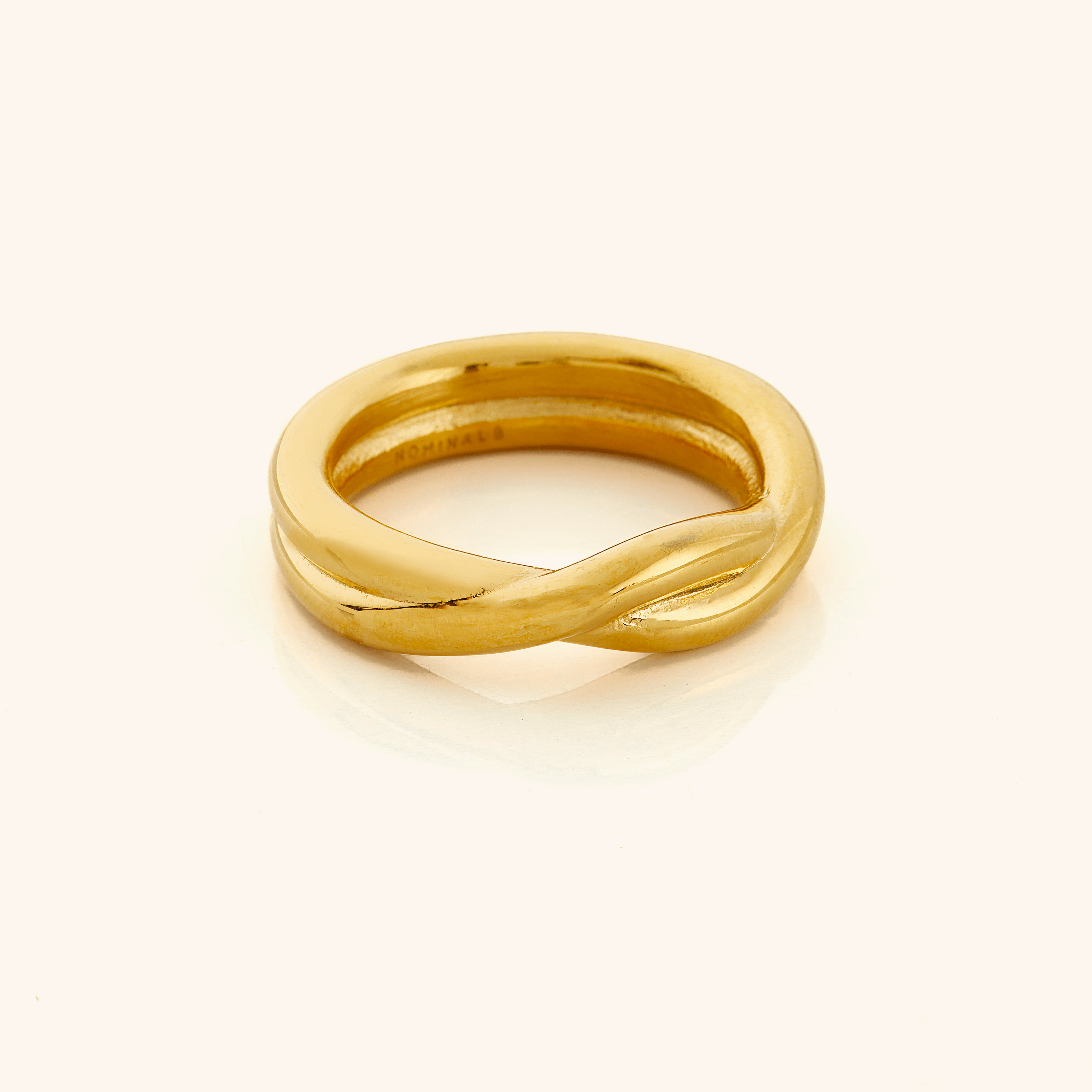 Intertwined Love Couple Rings close-up showing spiral design and gold finish.