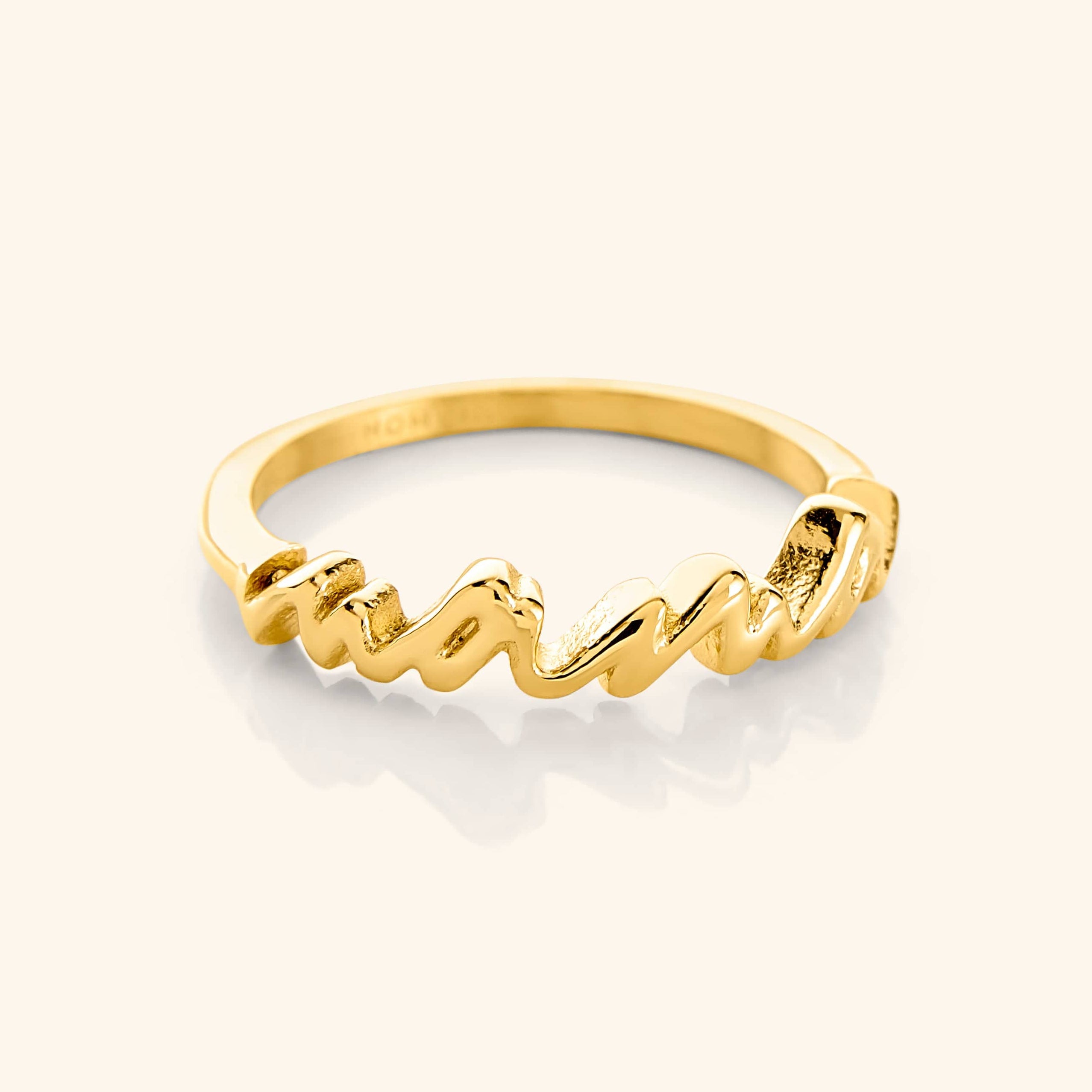 Mama's Heart Gold Band displayed elegantly against a soft velvet backdrop.