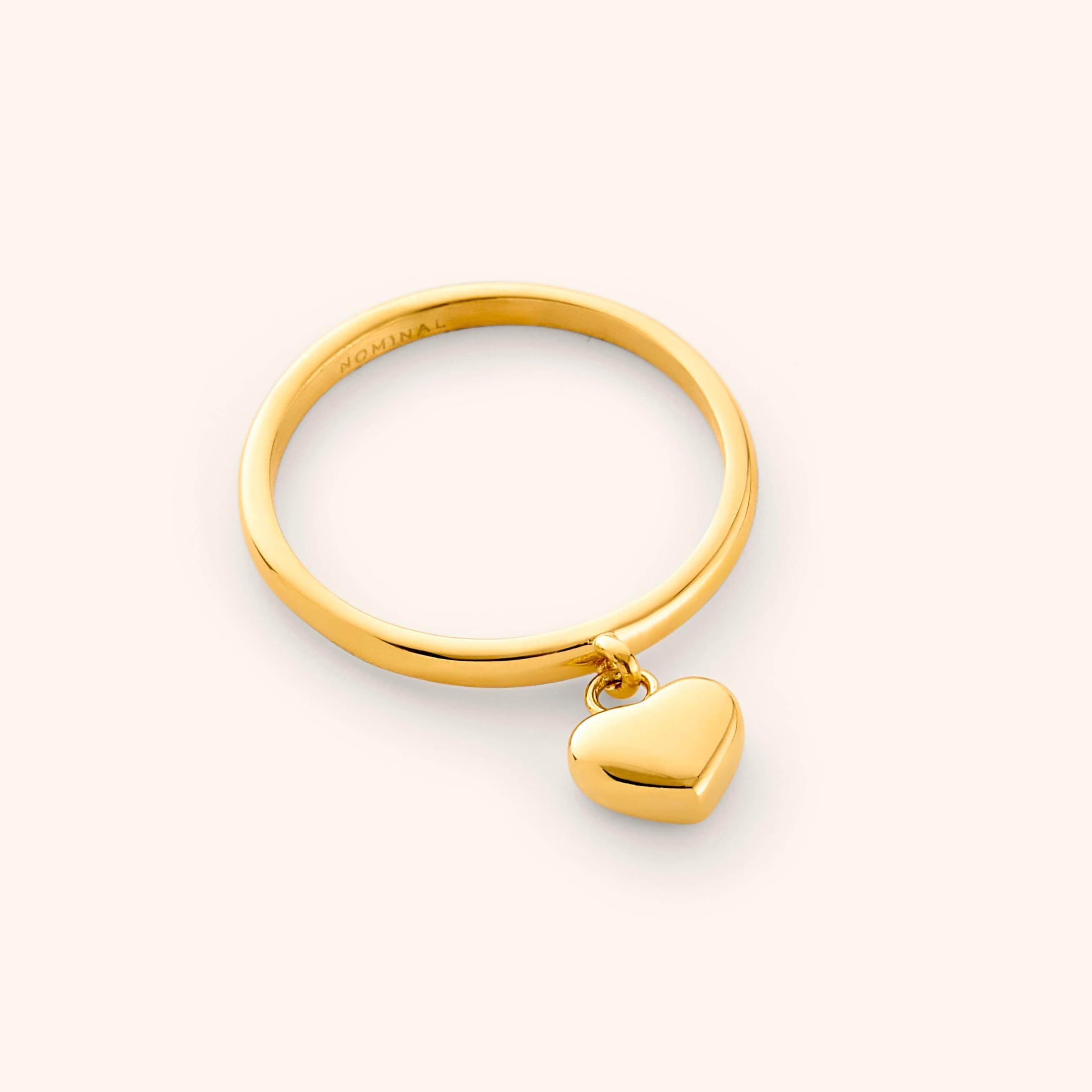 Elegant Gold Heart Loop Ring on a hand, showcasing its minimalist design.