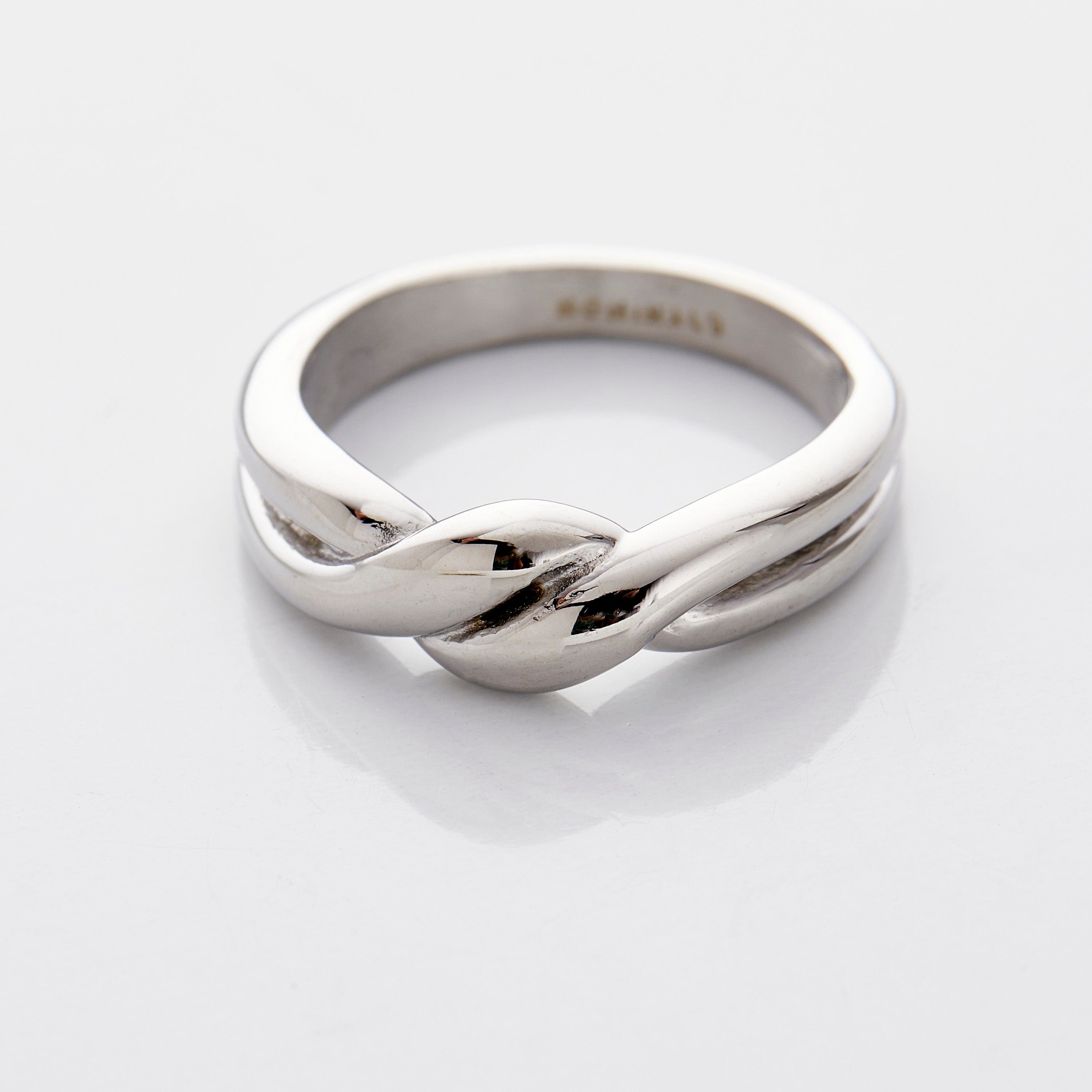 The knot ring displayed in a velvet pouch, emphasizing its elegant packaging.