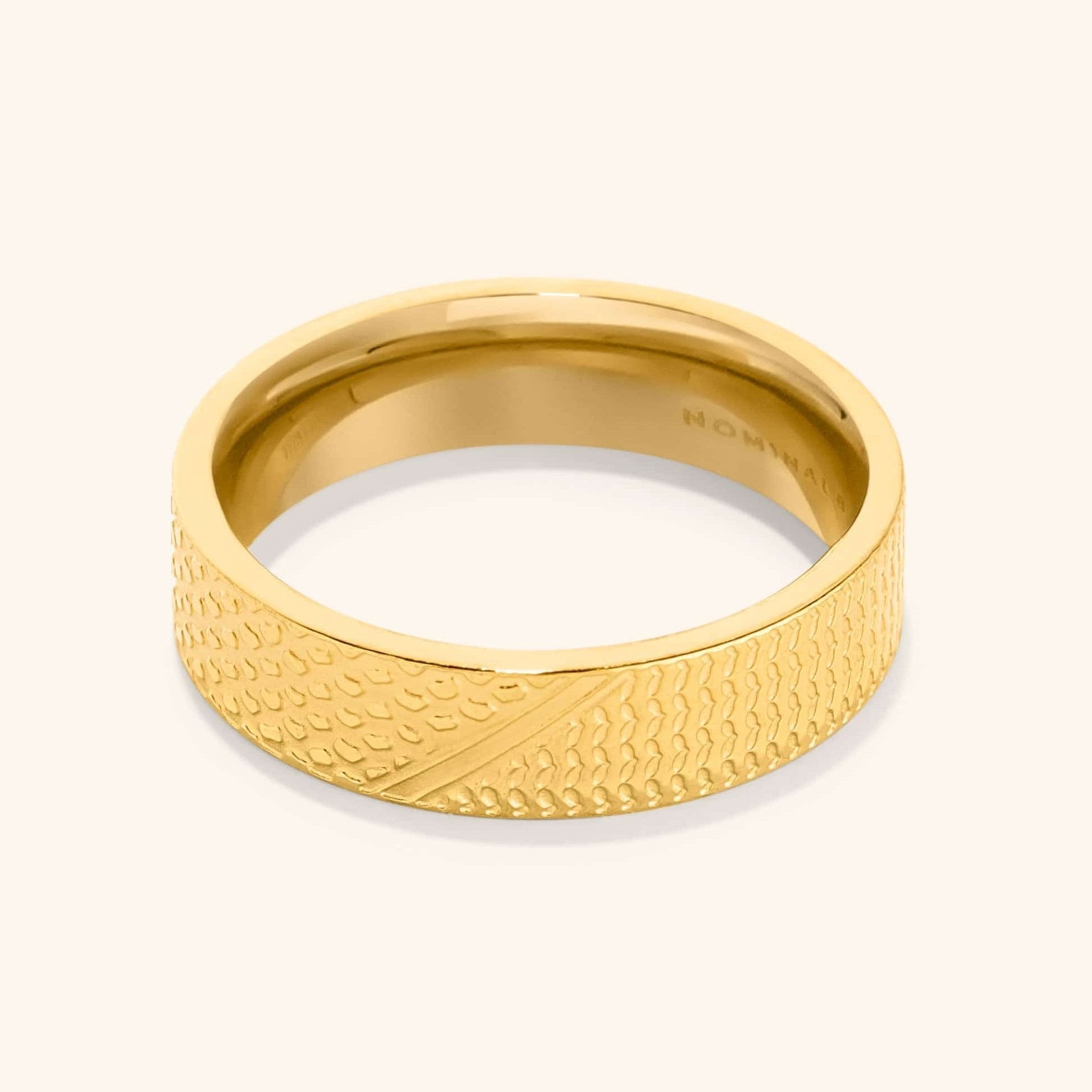 Close-up of the Keffiyeh ring showcasing intricate fishnet and olive leaf designs.