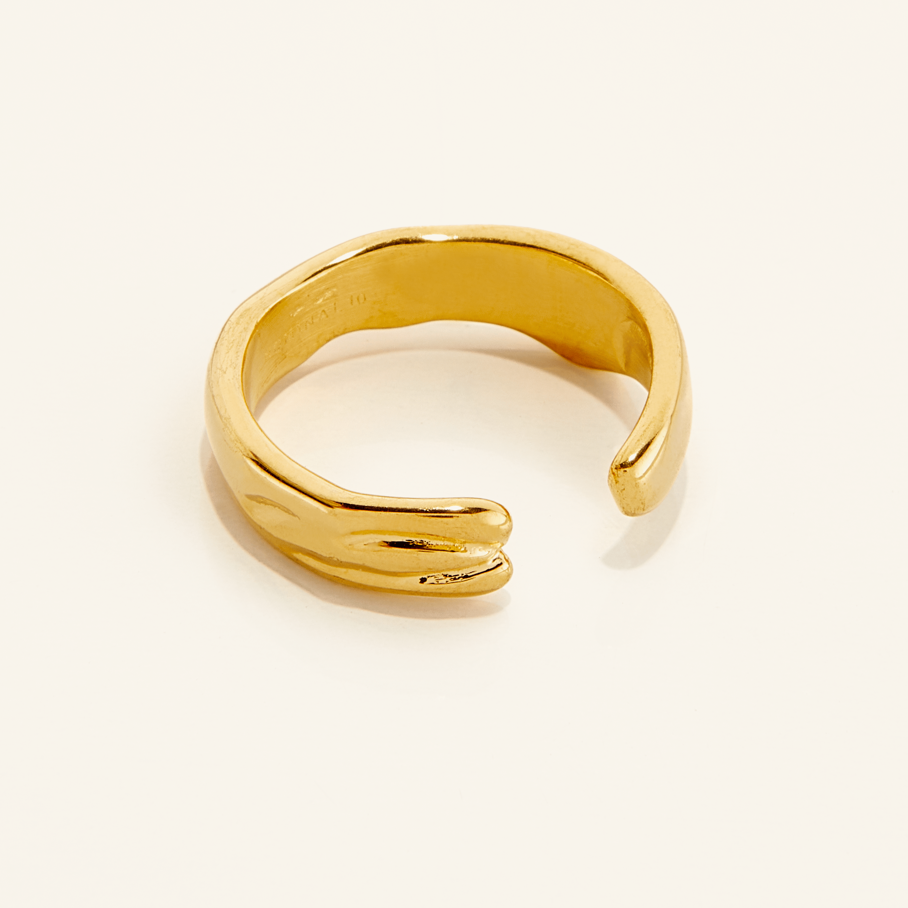 Fluid Molten Gold Ring displayed on a white background, showcasing its elegant ridges and shine.