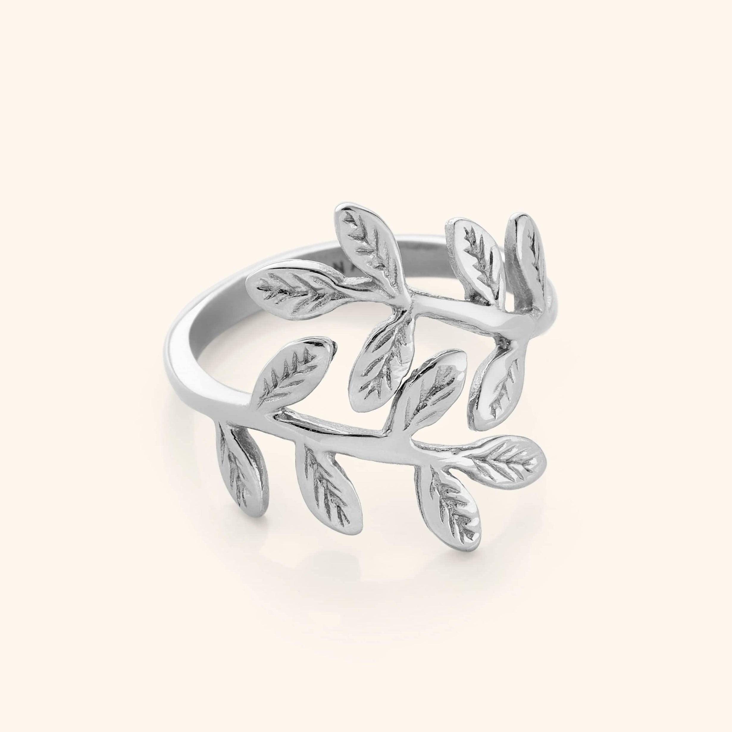 Olive leaf ring in a natural setting, emphasizing its connection to nature.