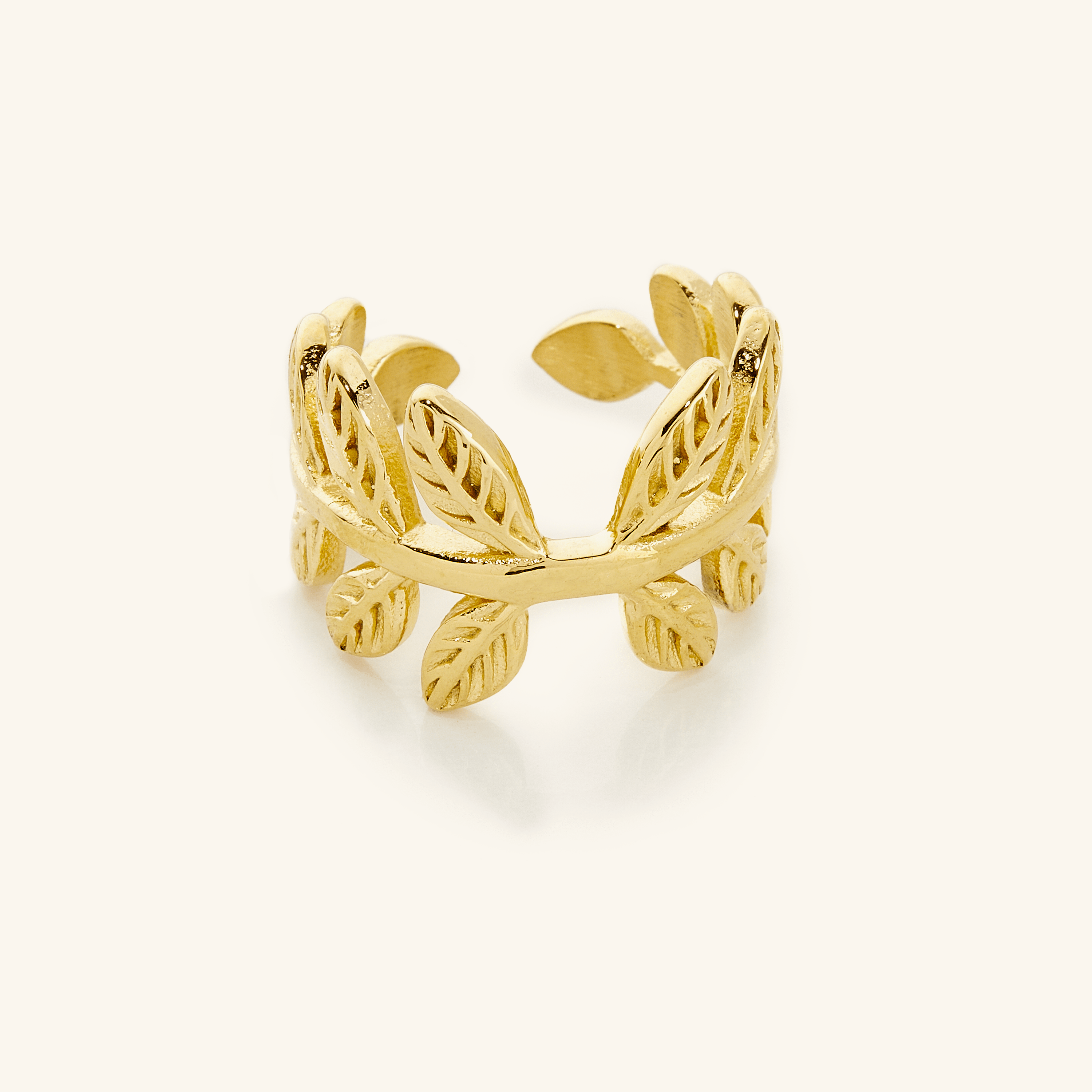 Trendy olive branch ring showcased on a velvet background, highlighting its elegant design.