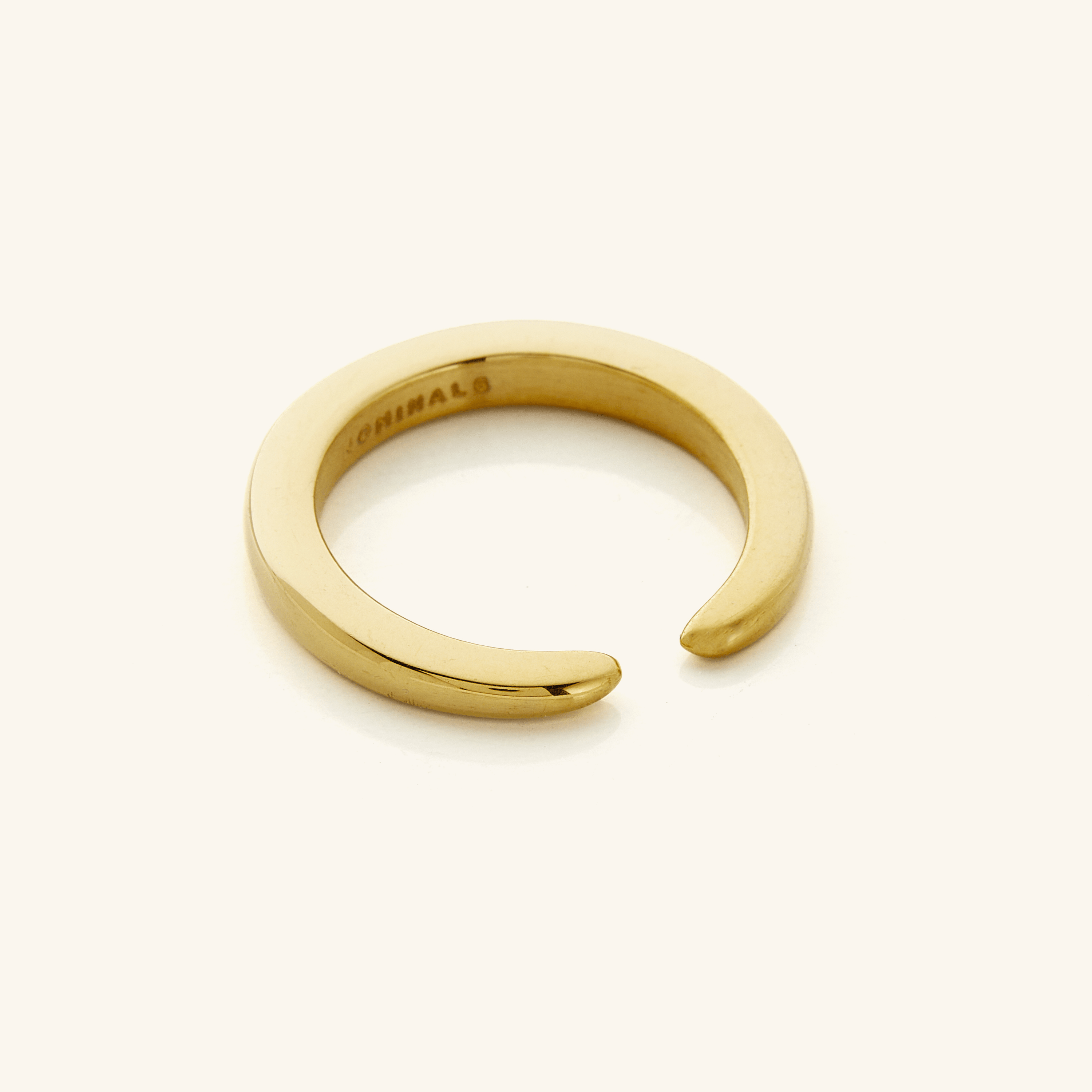 Close-up of Radiant Open Gap Gold Ring highlighting its shiny gold finish.