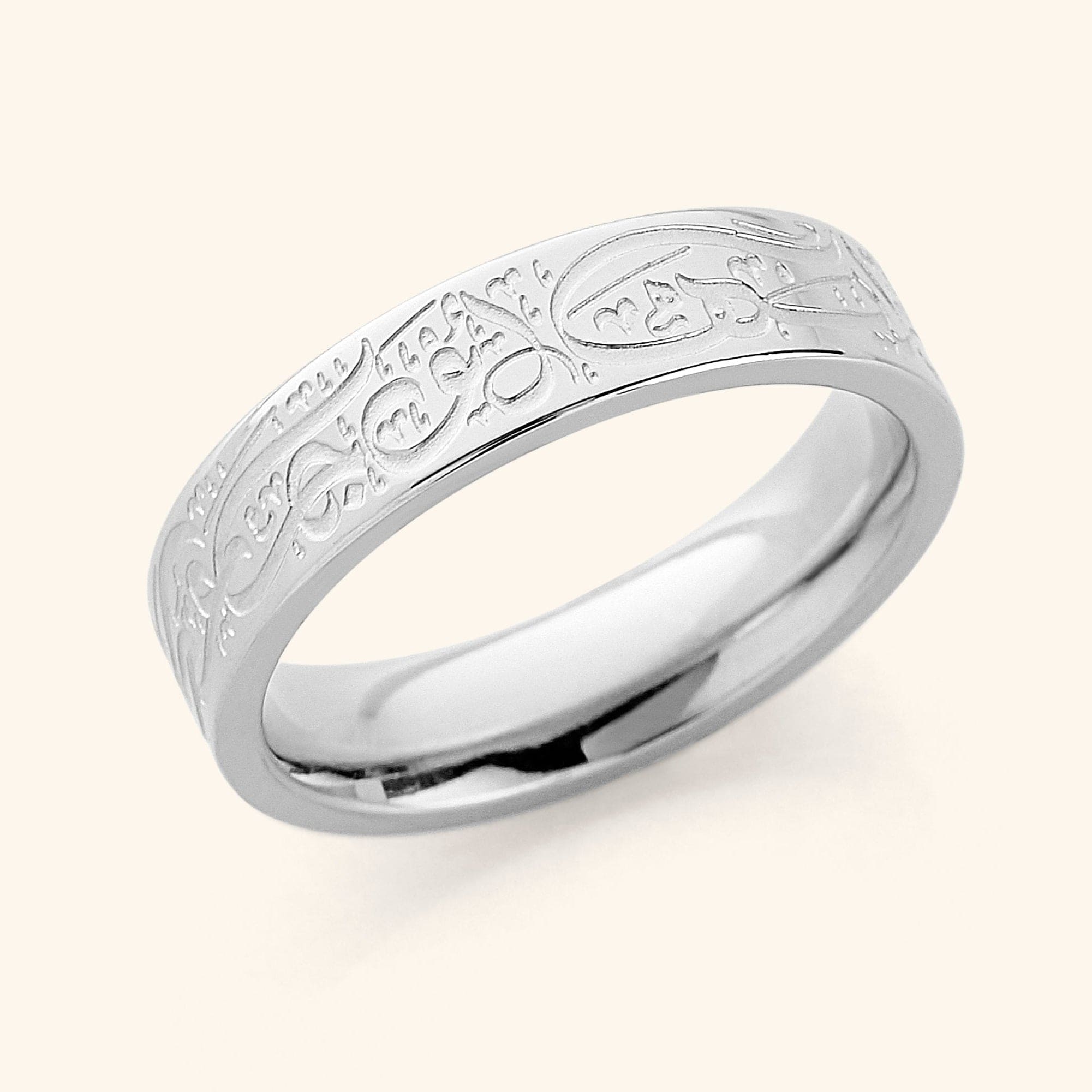 Close-up of Rumis inspirational ring showing the inscription and gold plating.