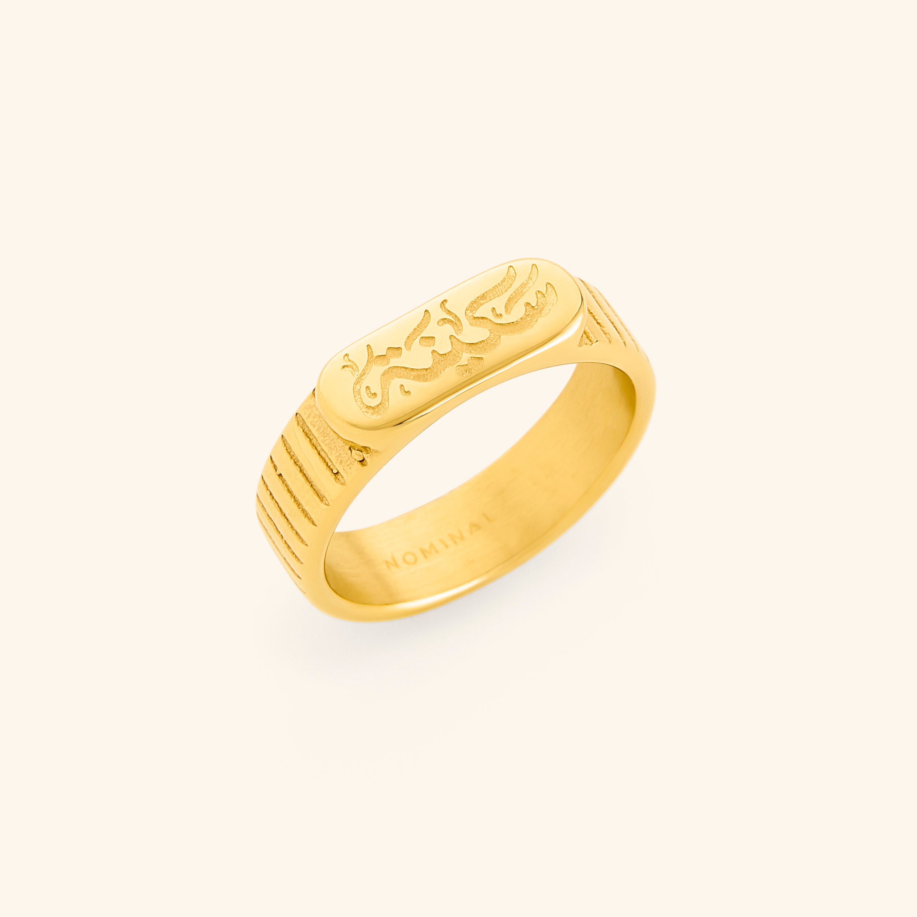 Close-up of the gold plated ring showing 'Sakinah' Arabic engraving and oval top detail