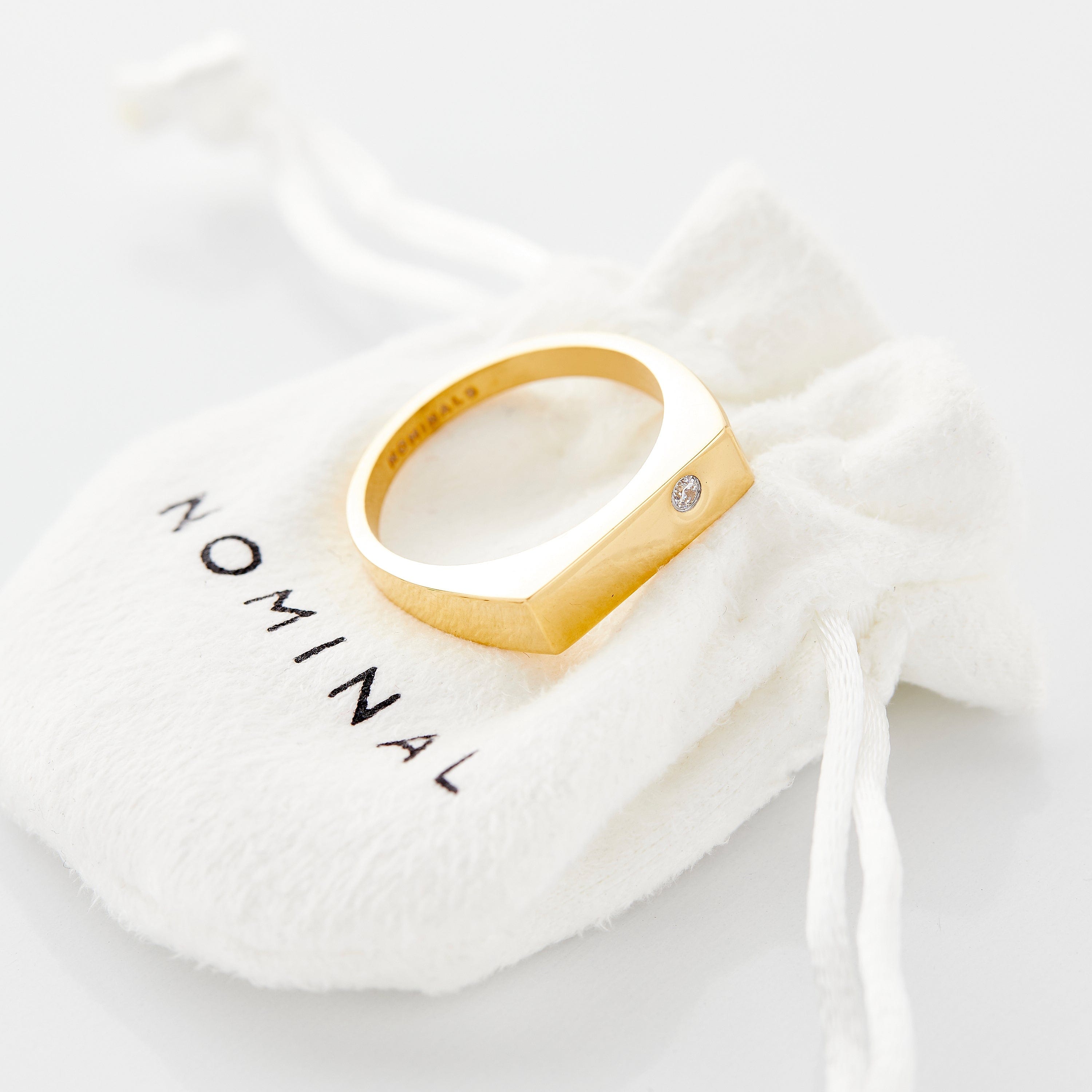 Side-angle shot showcasing flat-top bezel and waterproof build of the gold ring