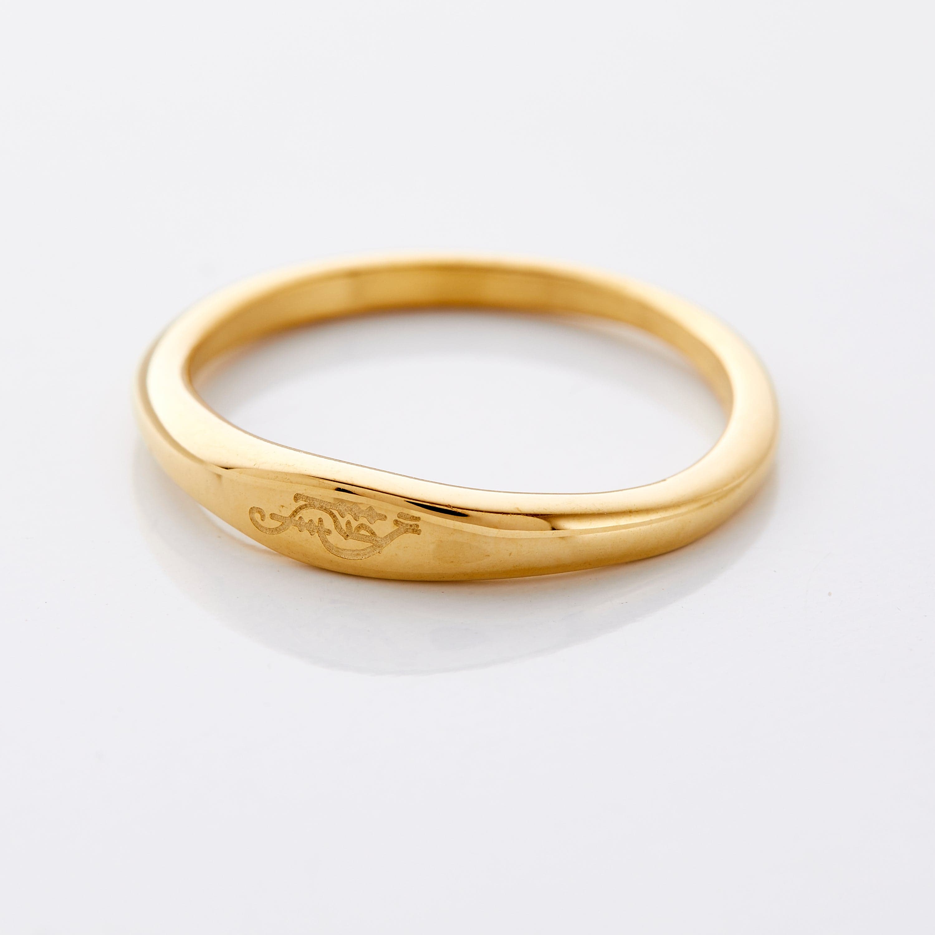 Close-up of the sisterhood signet ring showcasing Arabic calligraphy.
