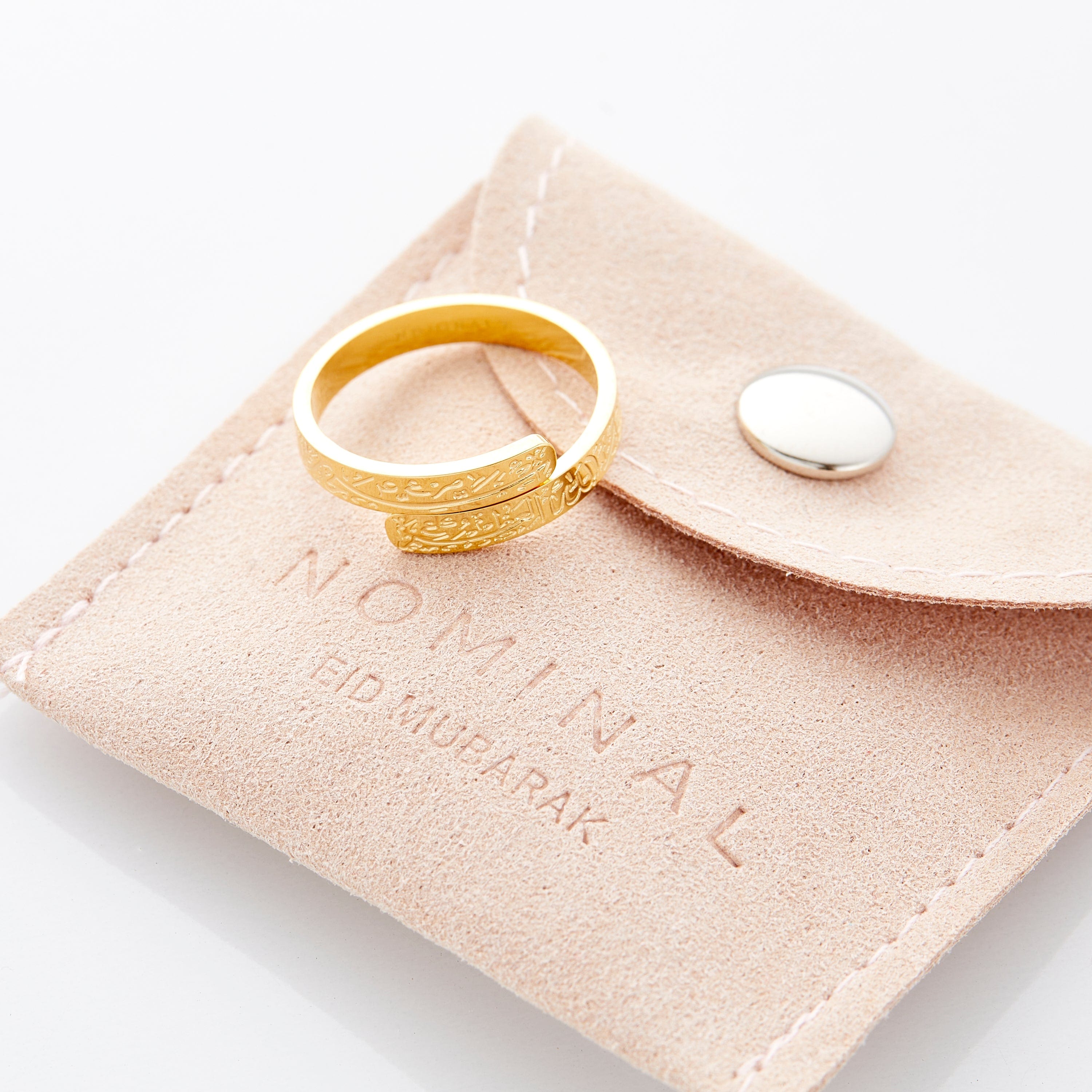 Lifestyle image of the gold thikr wrap ring worn on a finger, symbolizing spiritual connection.