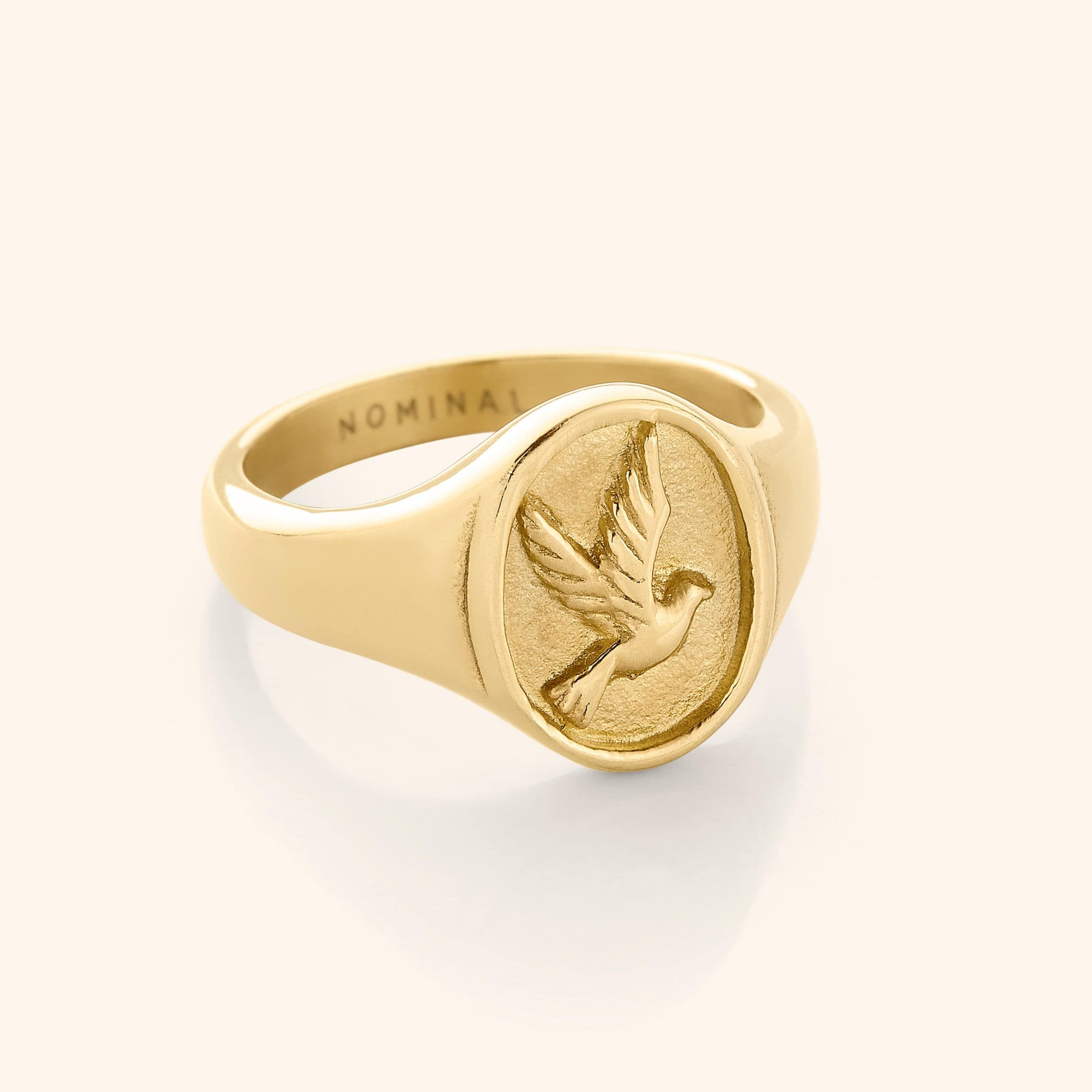Close-up of the tranquility dove ring showing its elegant design and gold finish.