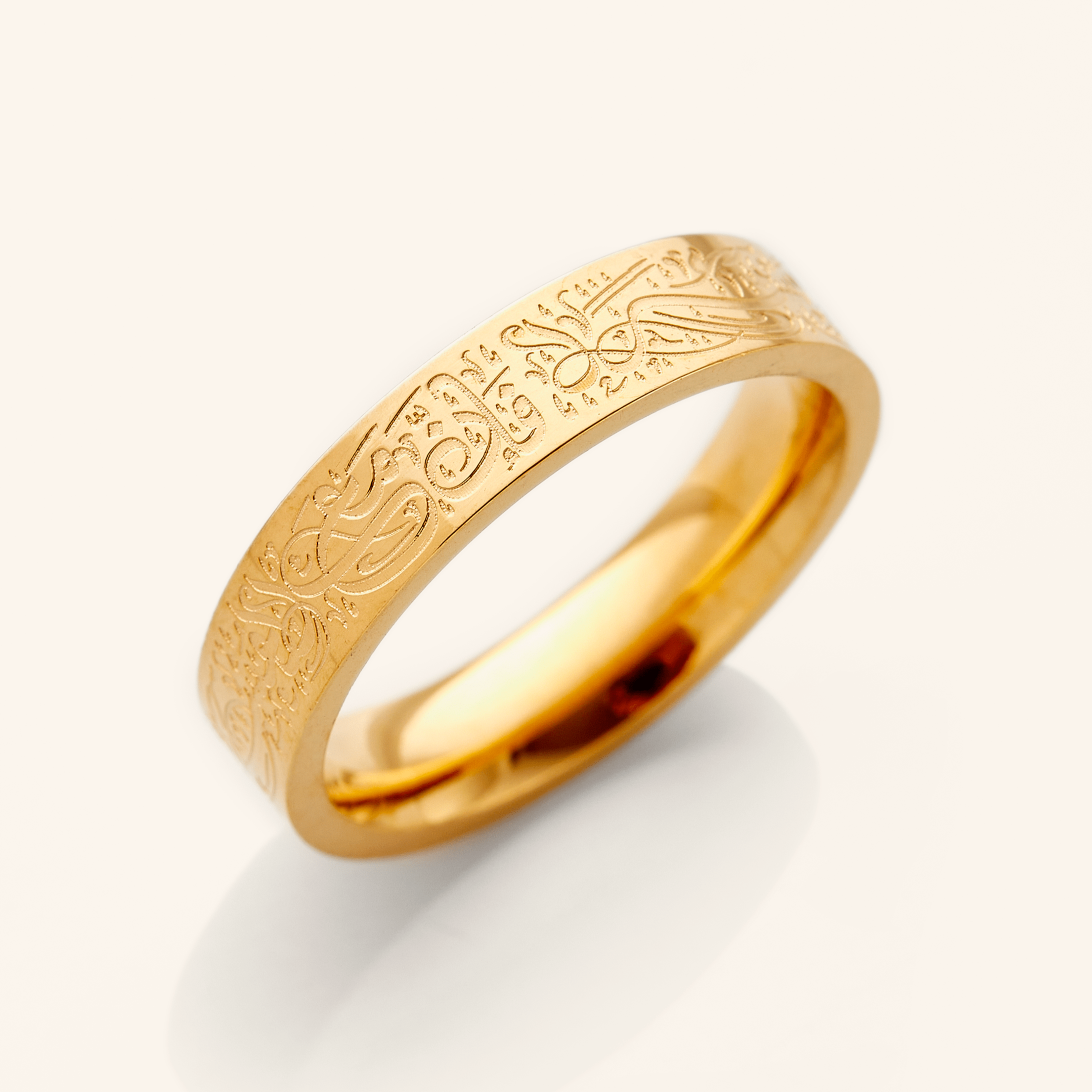 Resilient Spirit Engraved Gold Ring showcasing Arabic calligraphy from the side angle.