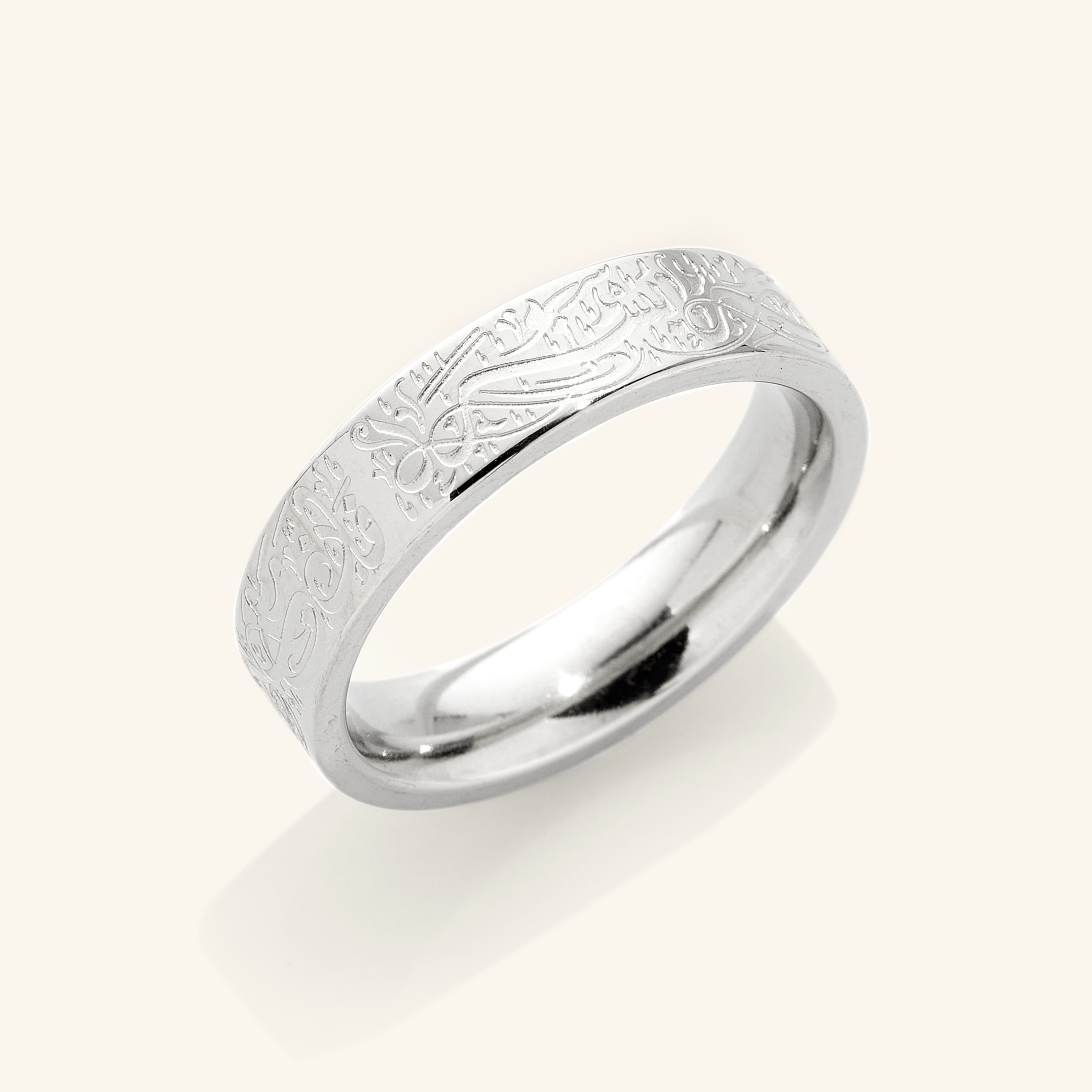 Close-up of the engraved gold ring highlighting the detailed Arabic script.