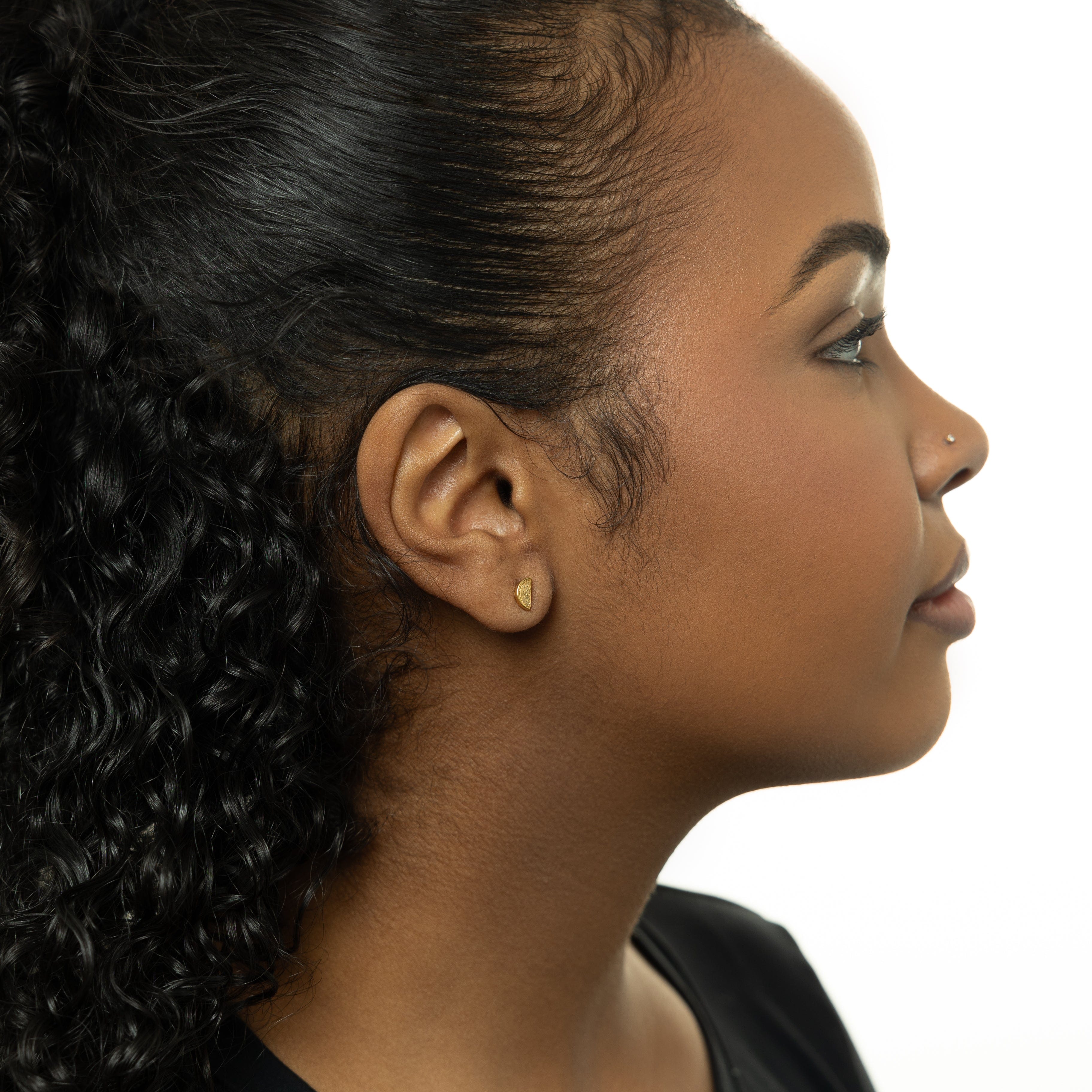 Close-up of vibrant watermelon studs showcasing their intricate design and gold plating.