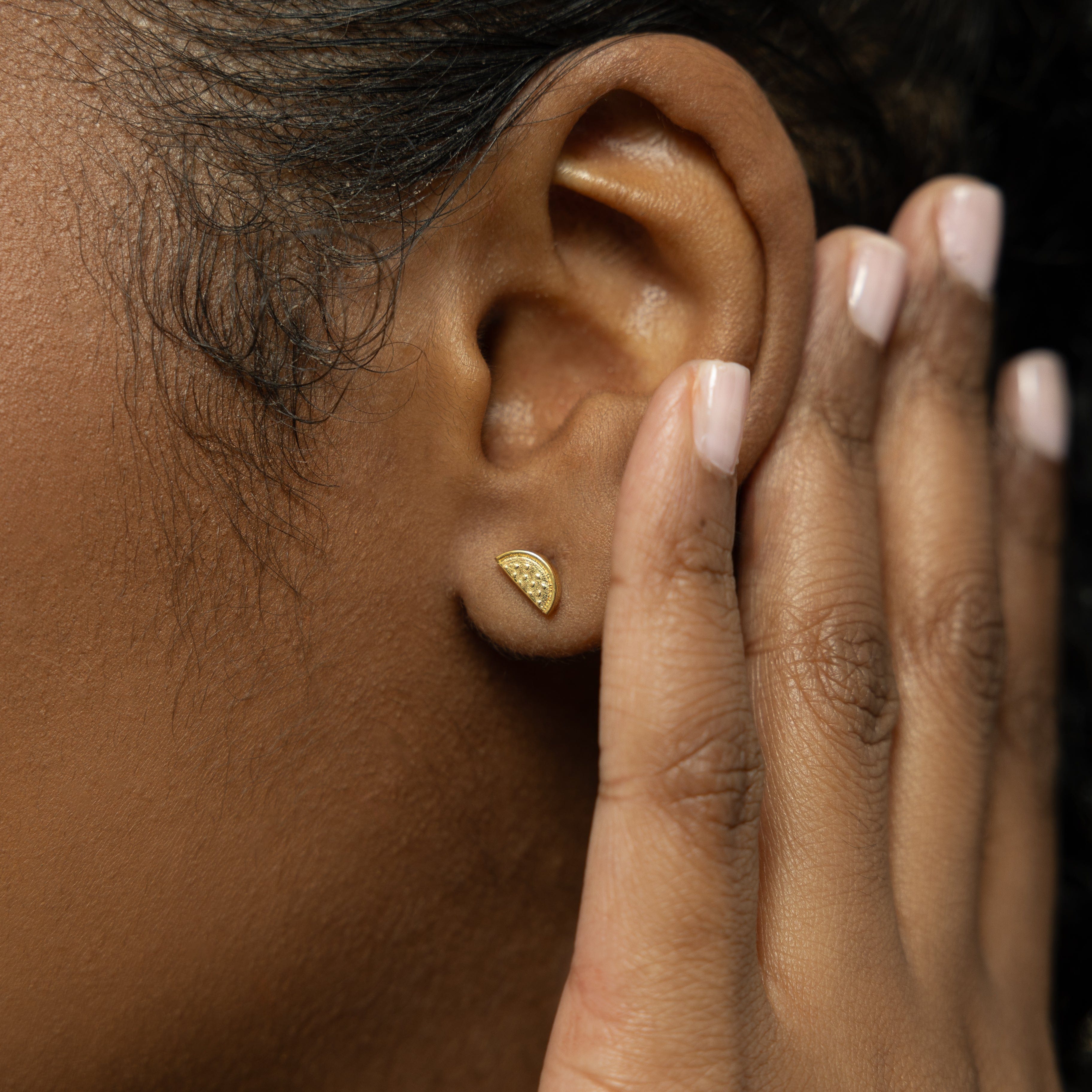 Model wearing watermelon statement studs, highlighting their elegance and versatility.