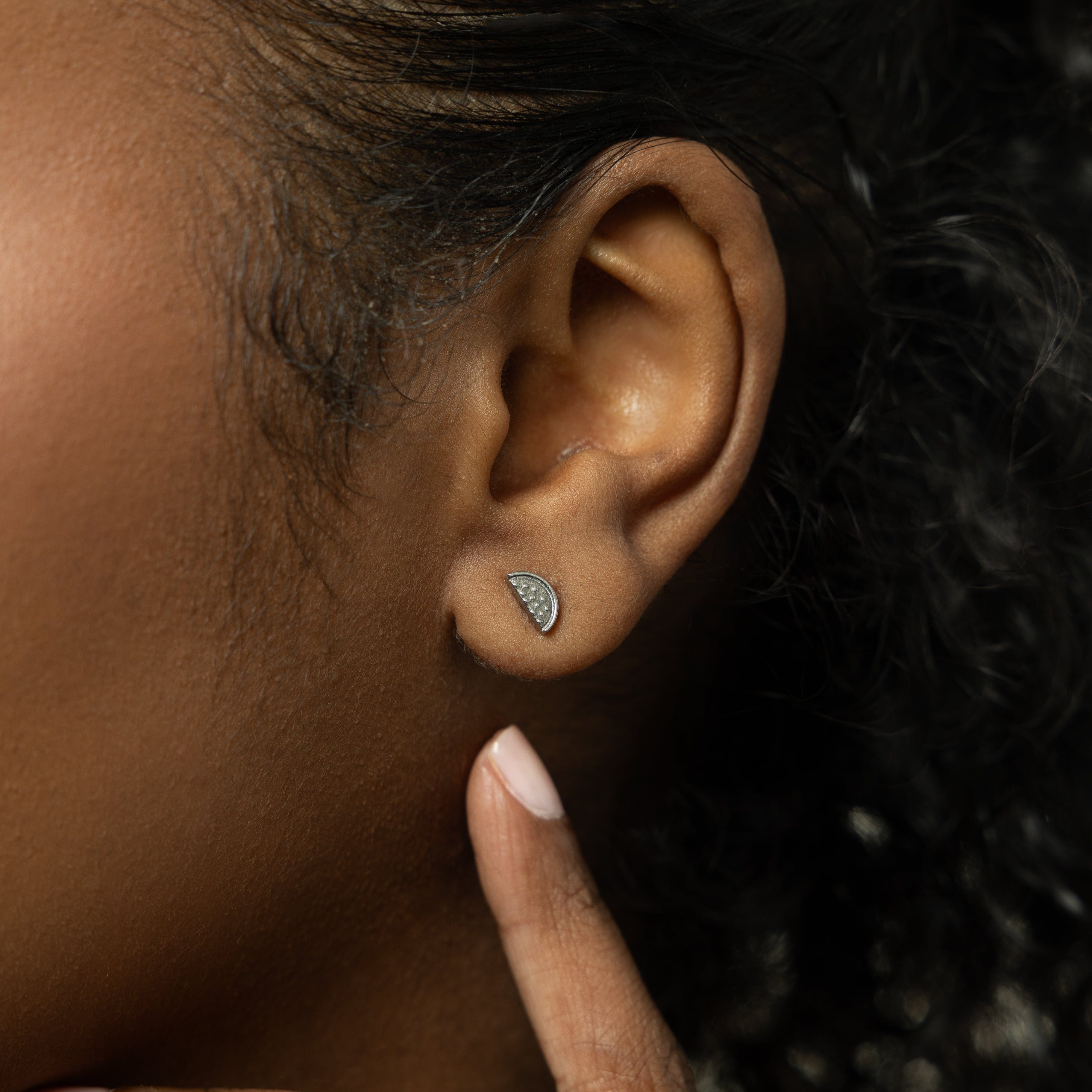 The watermelon studs displayed in a velvet pouch, perfect for gifting or personal use.