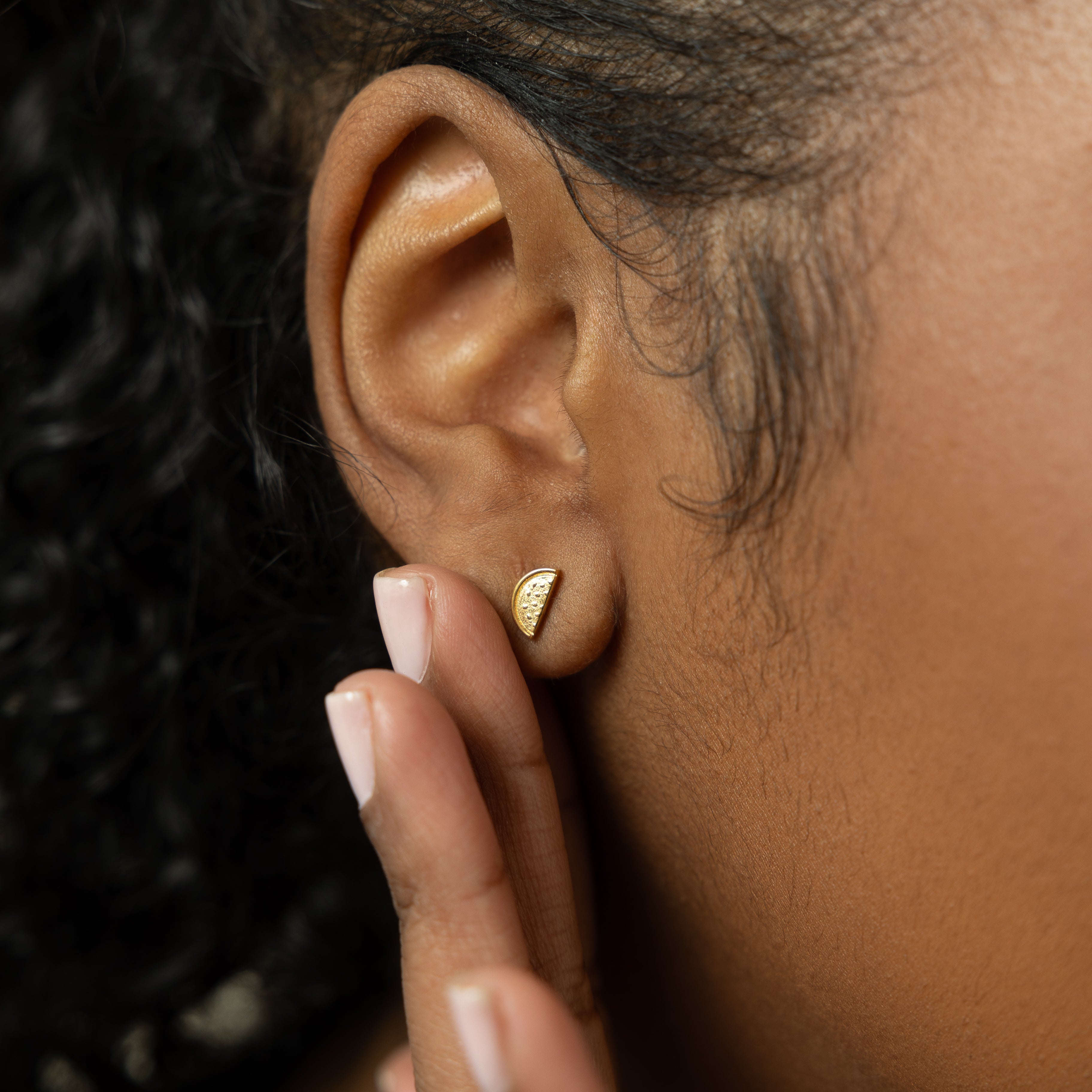 The watermelon studs displayed in a velvet pouch, perfect for gifting or personal use.